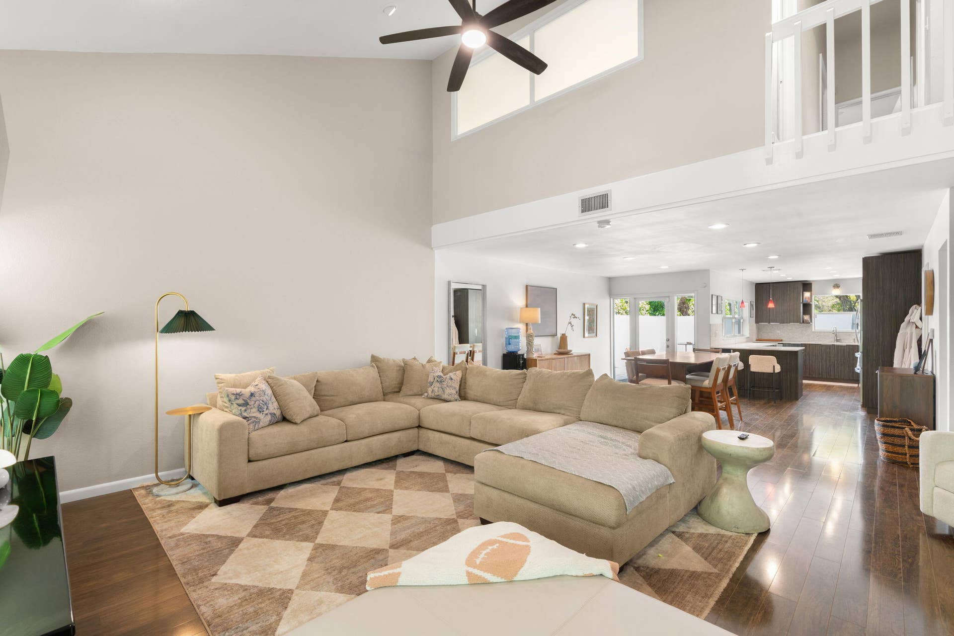 2956 FLORIDA Boulevard, Delray Beach, Delray Beach, FL 33483 Living room with vaulted ceilings, large windows, and an open layout that flows into the dining area and kitchen.