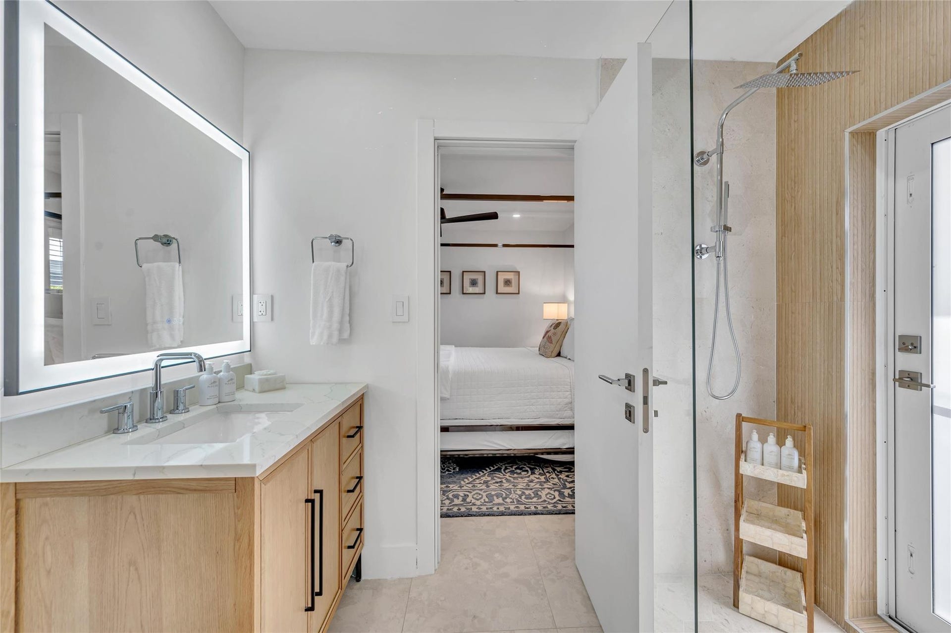 Guest Bathroom - Spa-like dual shower with Moen digital controls connected to high-end Delta Rainfall showerheads with separate handheld. This Bathroom doubles as a Cabana bath with outdoor shower and access to the pool! Vanity with lit mirror and power outlets in the vanity for hair driers etc.