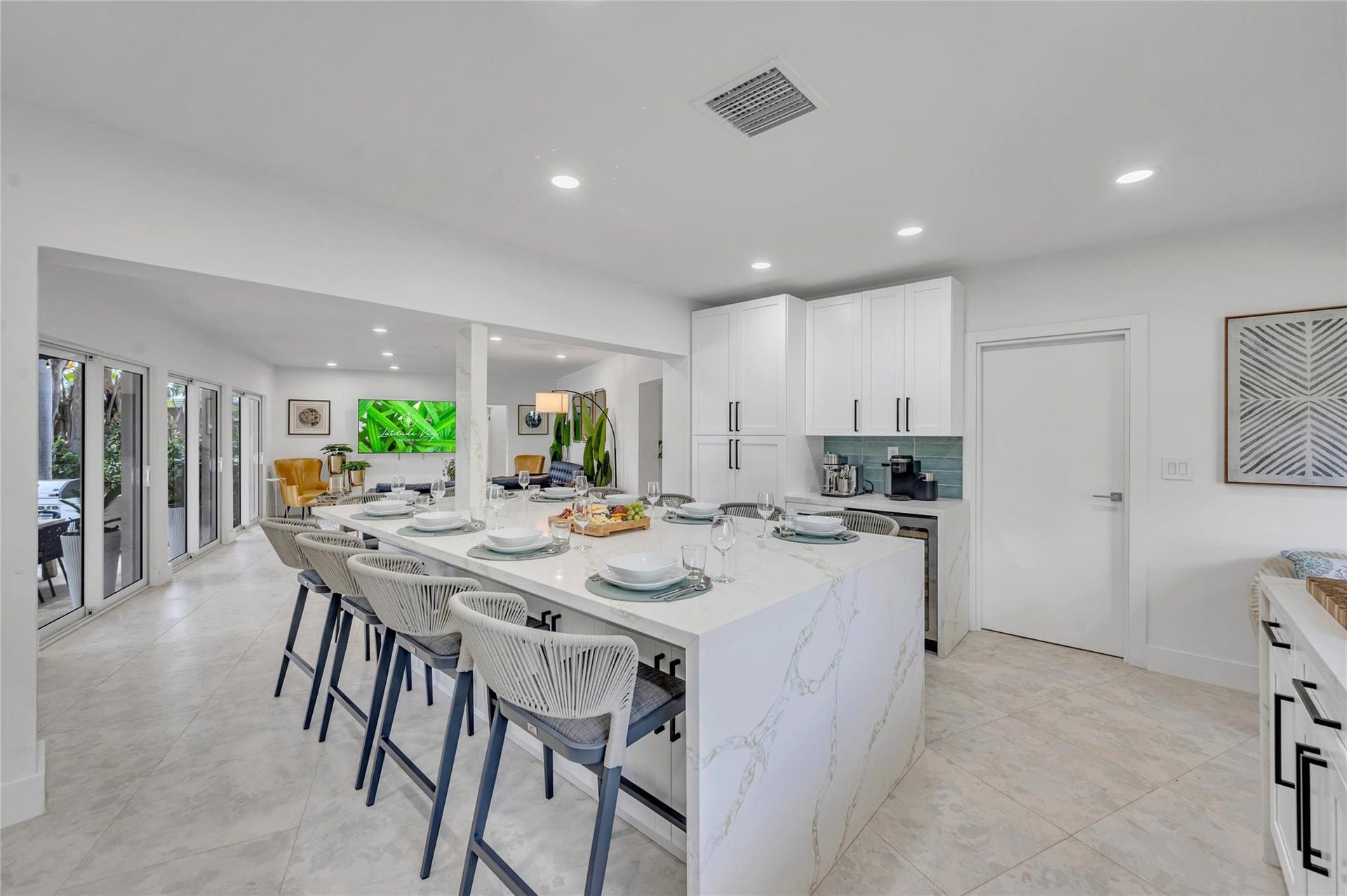 Solid wood cabinetry with soft-close hardware. Quartz countertops with stunning waterfall edge Massive island with seating for 10. High-end appliances: 36 natural gas oven range, vent hood, dishwasher, refrigerator, microwave
