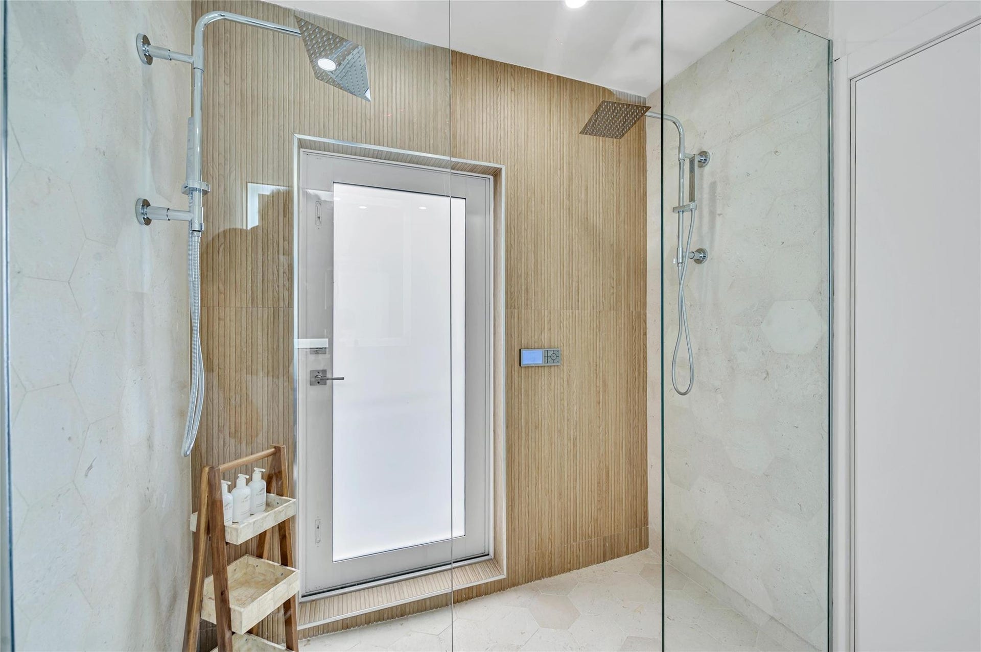 Guest Bathroom - Spa-like dual shower with Moen digital controls connected to high-end Delta Rainfall showerheads with separate handheld. This Bathroom doubles as a Cabana bath with outdoor shower and access to the pool! Vanity with lit mirror and power outlets in the vanity for hair driers etc.