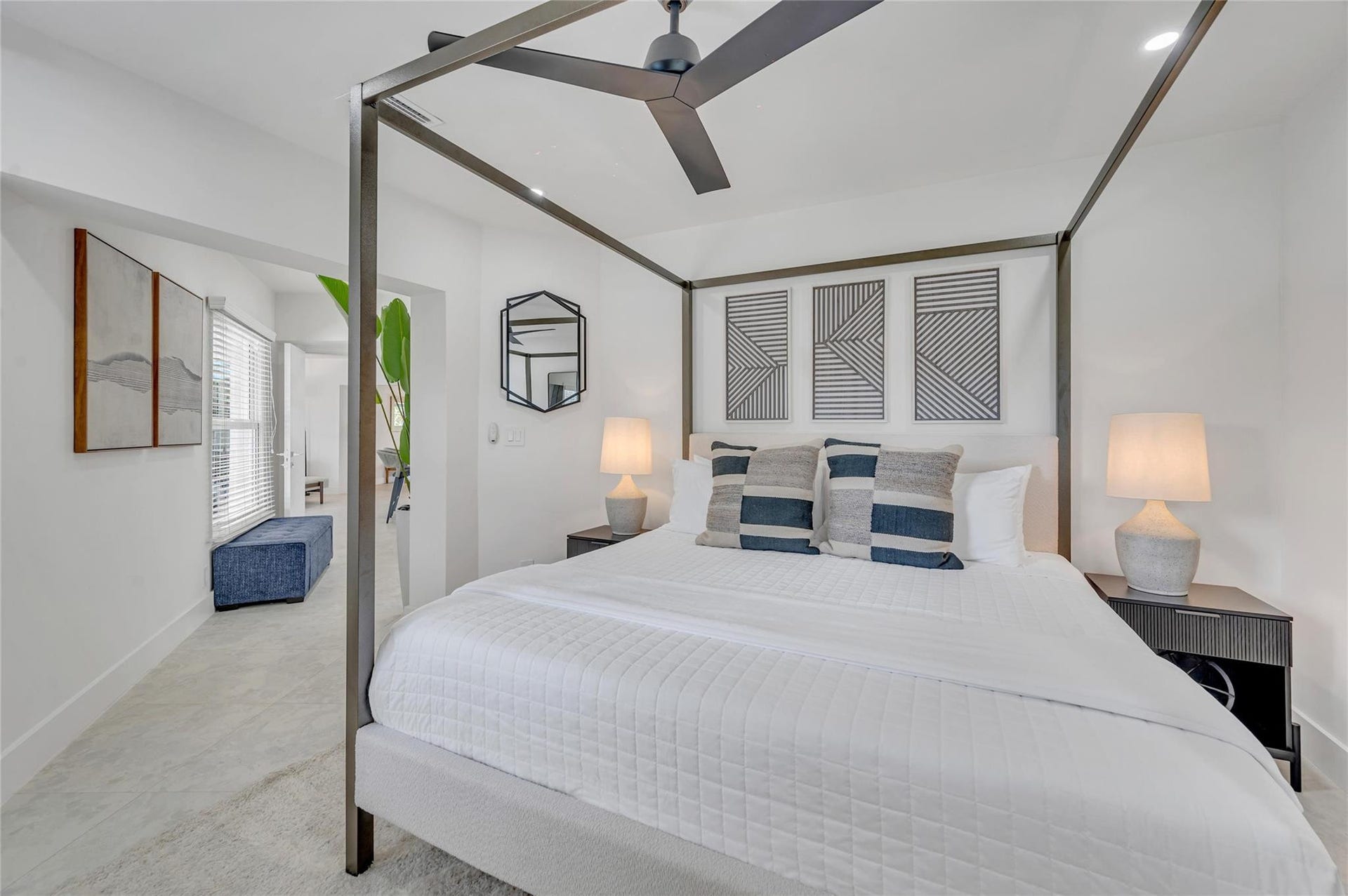 Primary Bedroom isolated from the guest bedrooms. Has a view to the back of pool and straight down the canal. Additionally a beautiful high end finishes in the primary bathroom and walk in closet.