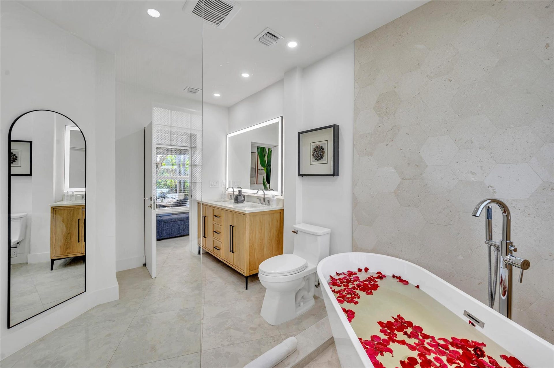 Spa-like master bathroom, Dual shower with Moen digital controls connected to high-end Delta shower head Rainfall showerheads with separate handheld and soaking tub. Dual vanities, with lit mirror and power outlets in the vanity for hair driers etc.