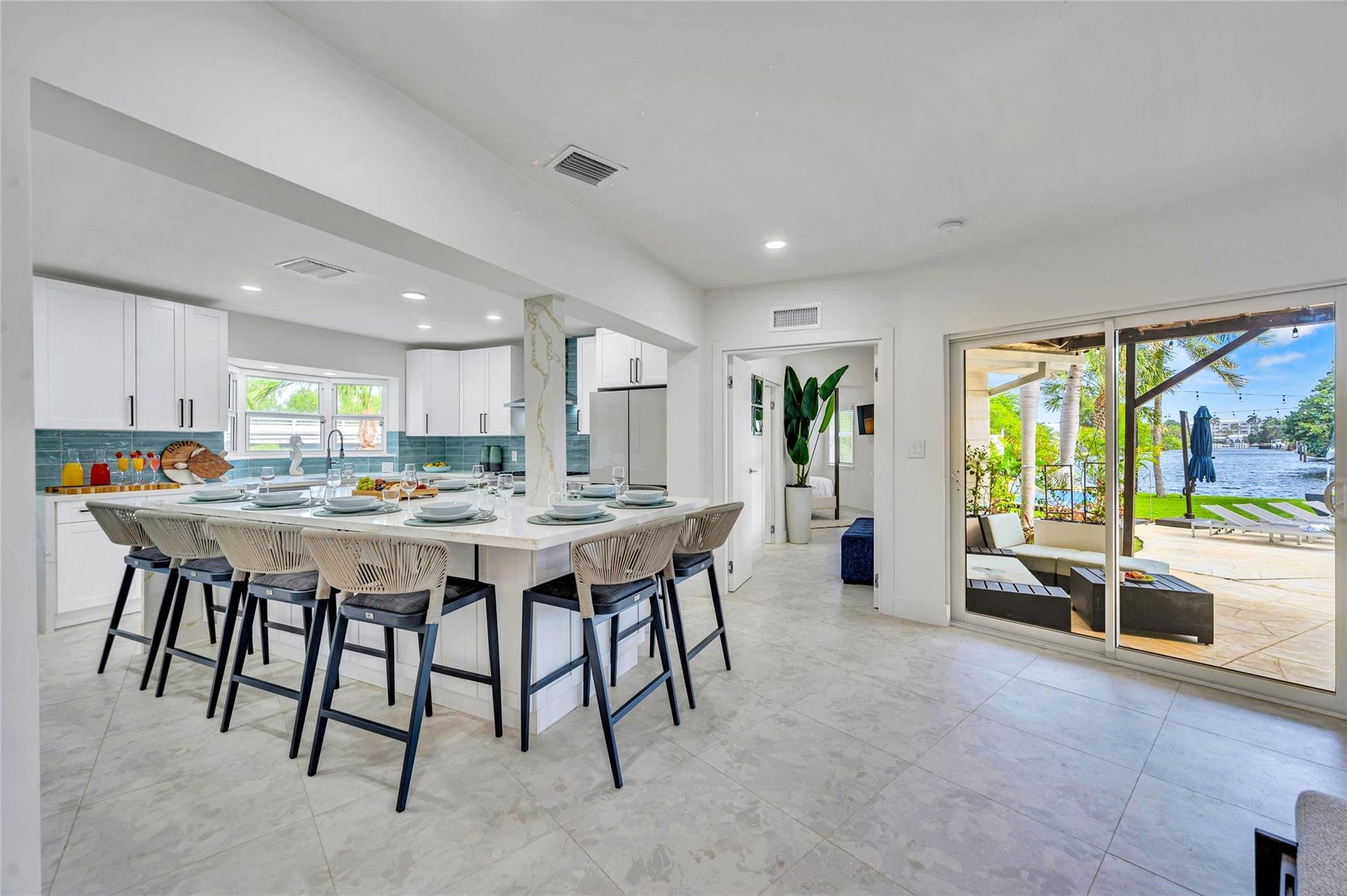 Solid wood cabinetry with soft-close hardware. Quartz countertops with stunning waterfall edge Massive island with seating for 10. High-end appliances: 36 natural gas oven range, vent hood, dishwasher, refrigerator, microwave