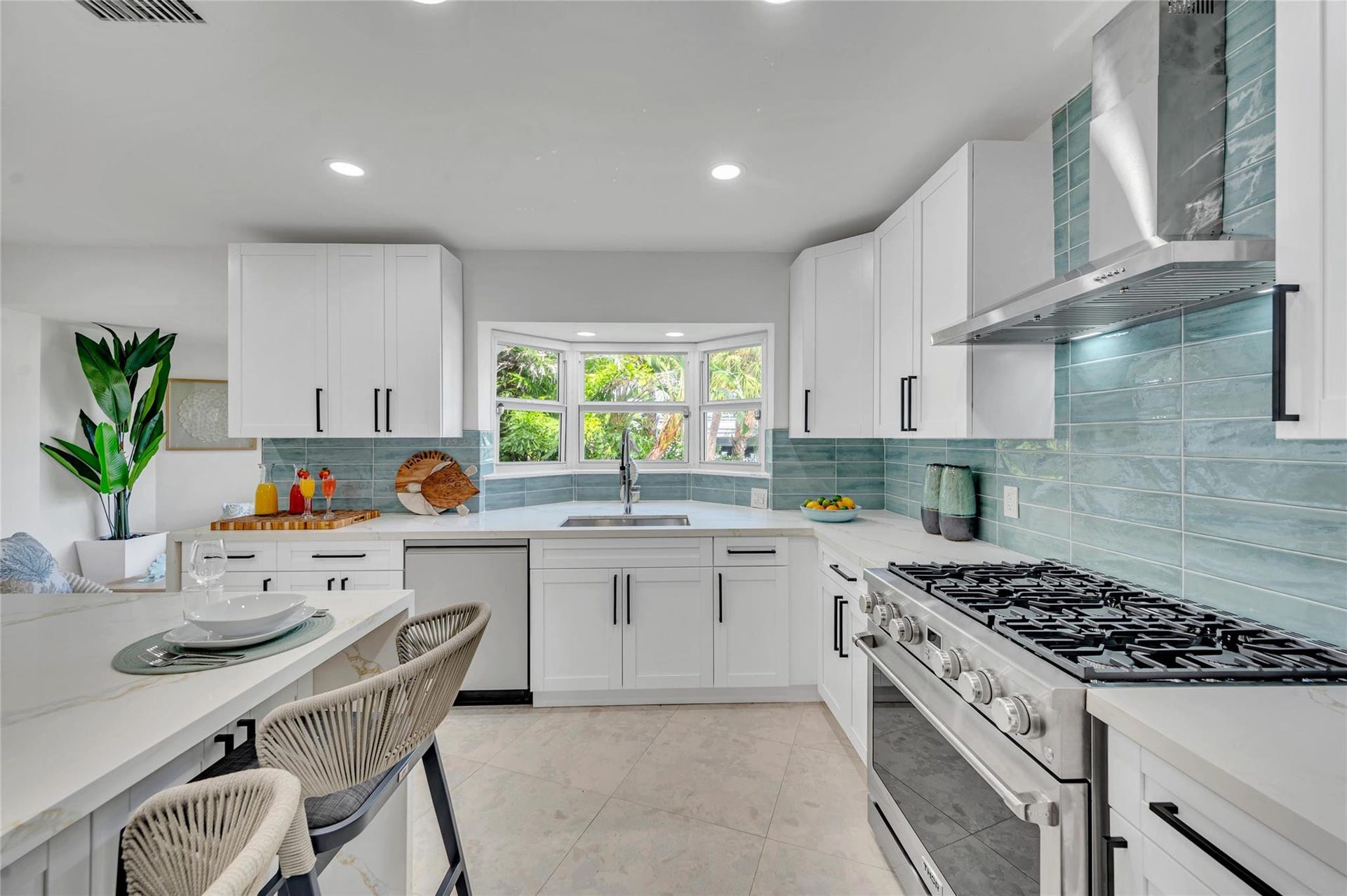 Solid wood cabinetry with soft-close hardware. Quartz countertops with stunning waterfall edge Massive island with seating for 10. High-end appliances: 36 natural gas oven range, vent hood, dishwasher, refrigerator, microwave