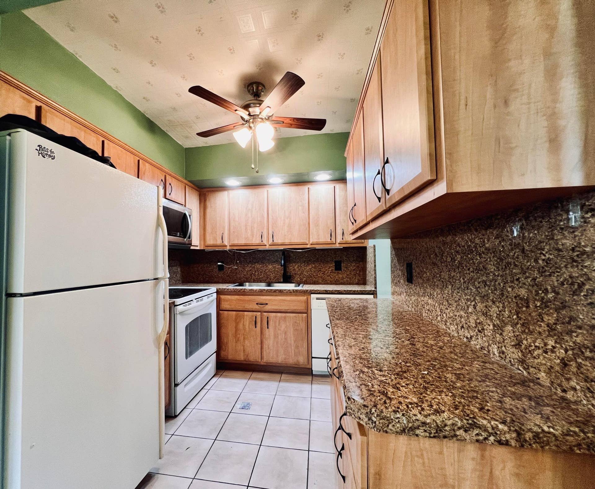 210 Easthampton I, West Palm Beach, FL 33417 Pretty Updated Kitchen With Rich Wood Tone Cabinets, Granite Look Counters. Full Appliance Package - Including A Dishwasher