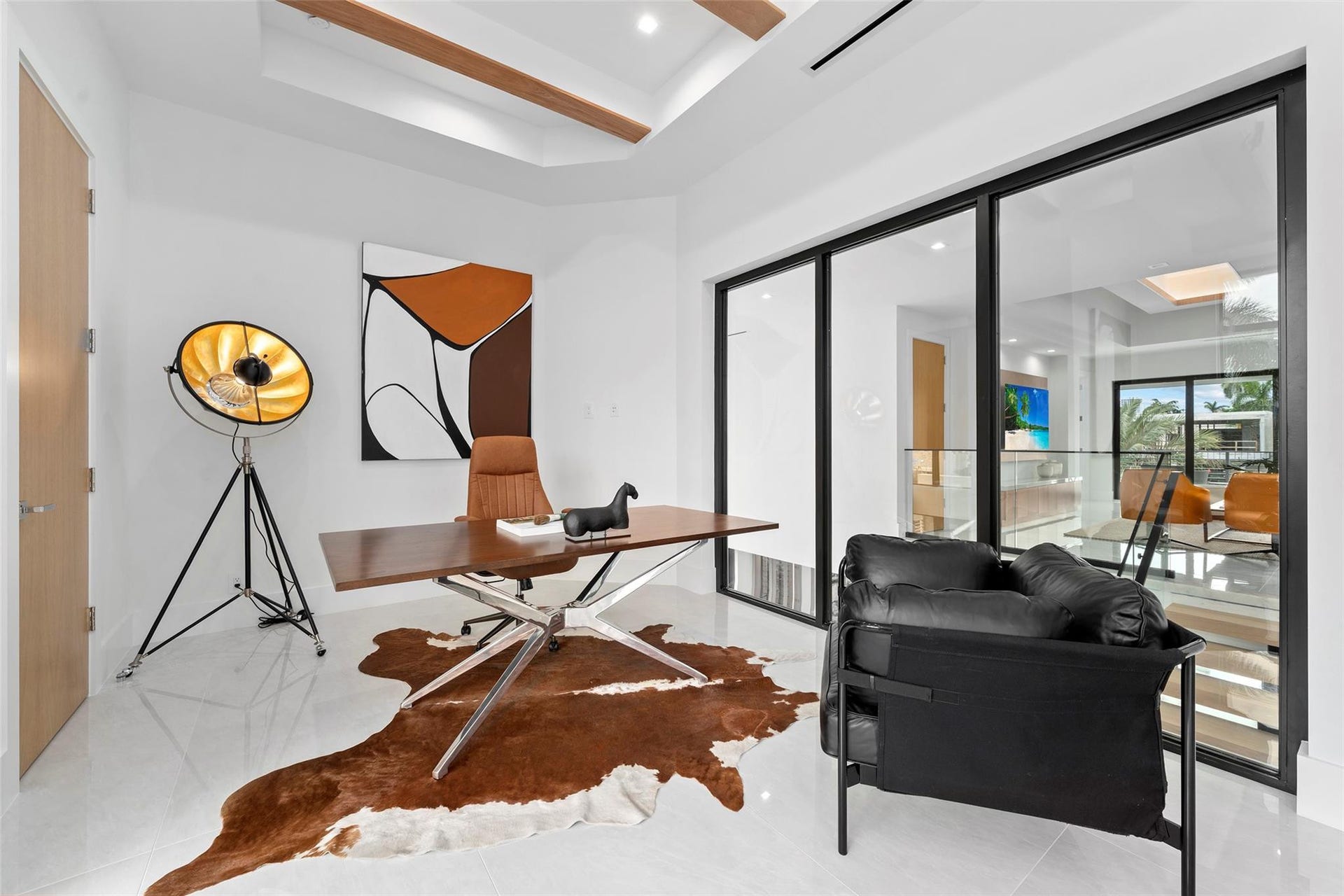 Fourth Bedroom with Striking Glass Wall Overlooking the Second-Floor Interior
