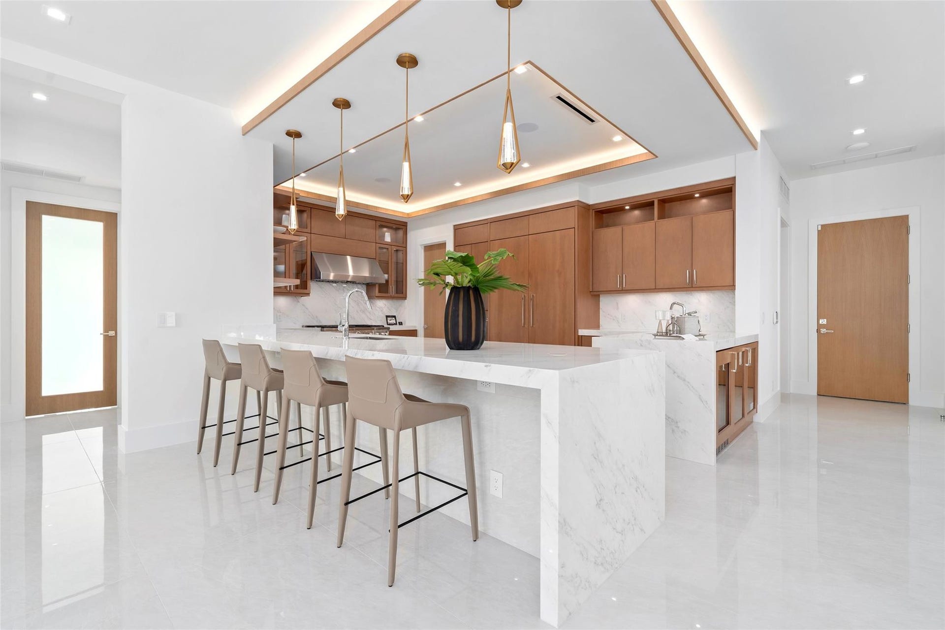 The gourmet kitchen is a chefs dream, featuring marble countertops, real wood cabinetry,