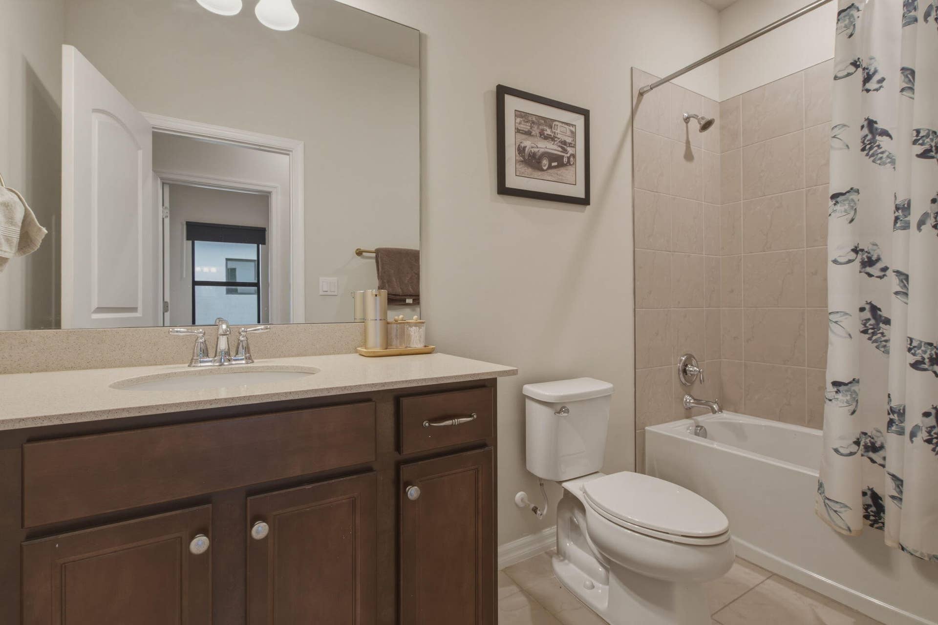 4601 Pinehurst Trail E, Oakland Park, FL 33309 Bathroom vanity featuring a light-toned countertop, undermount sink, and dark wood-finish cabinetry
