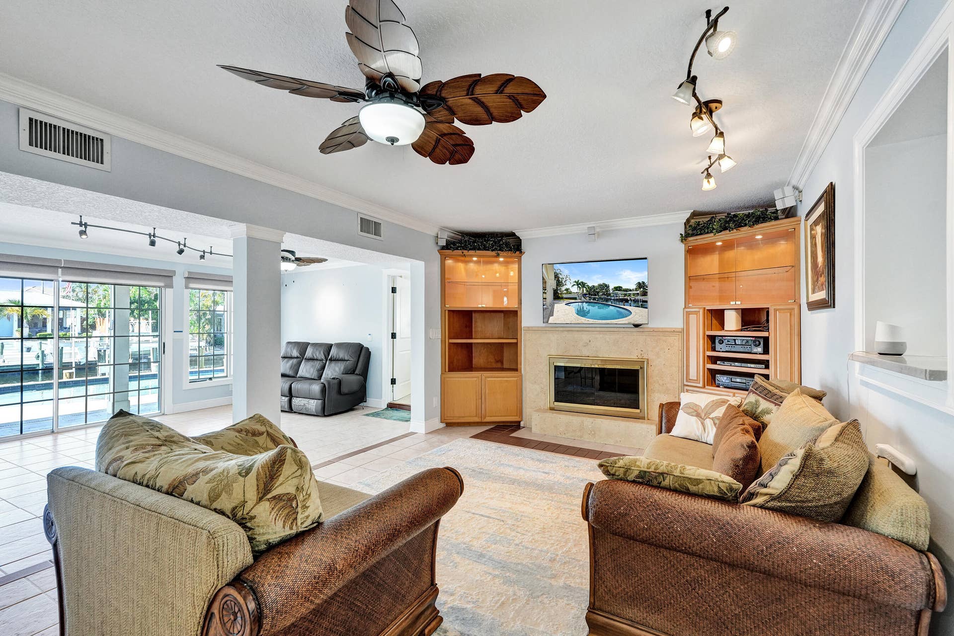 733 JACANA Way, North Palm Beach, FL 33408 There's so much natural light in this home. You'll find yourself wanting to spend most of your time in this oversized 25'10 x 27' room. This area of the home is so spacious, but is still cozy, with a gas fireplace and brick chimney. Surrounding the fireplace are custom maple built-in cabinets.