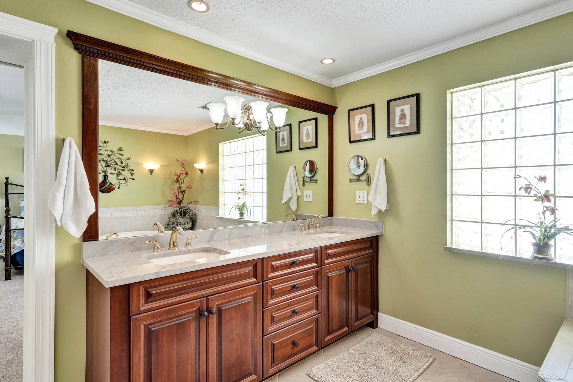 733 JACANA Way, North Palm Beach, FL 33408 Double vanity with cherry cabinetry.