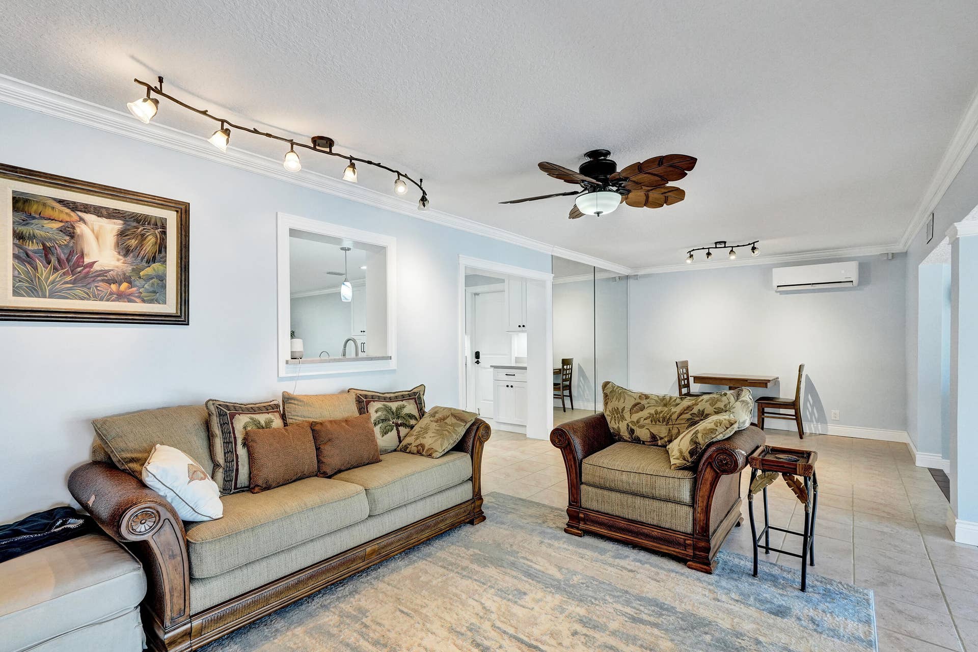 733 JACANA Way, North Palm Beach, FL 33408 Family room featuring neutral wall tones, crown molding and a pass-through window to the kitchen.