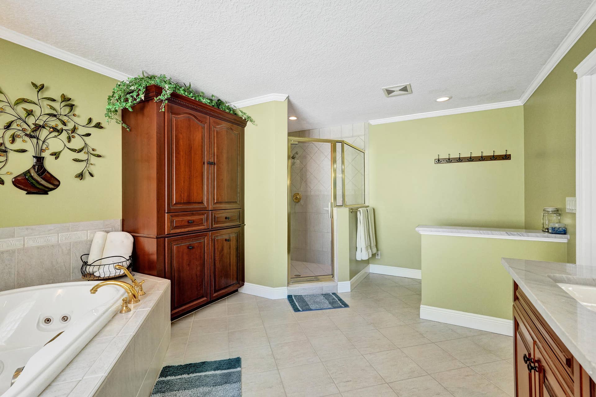 733 JACANA Way, North Palm Beach, FL 33408 Spacious bathroom with built in cherry armoire, 2 person jacuzzi and separate shower.