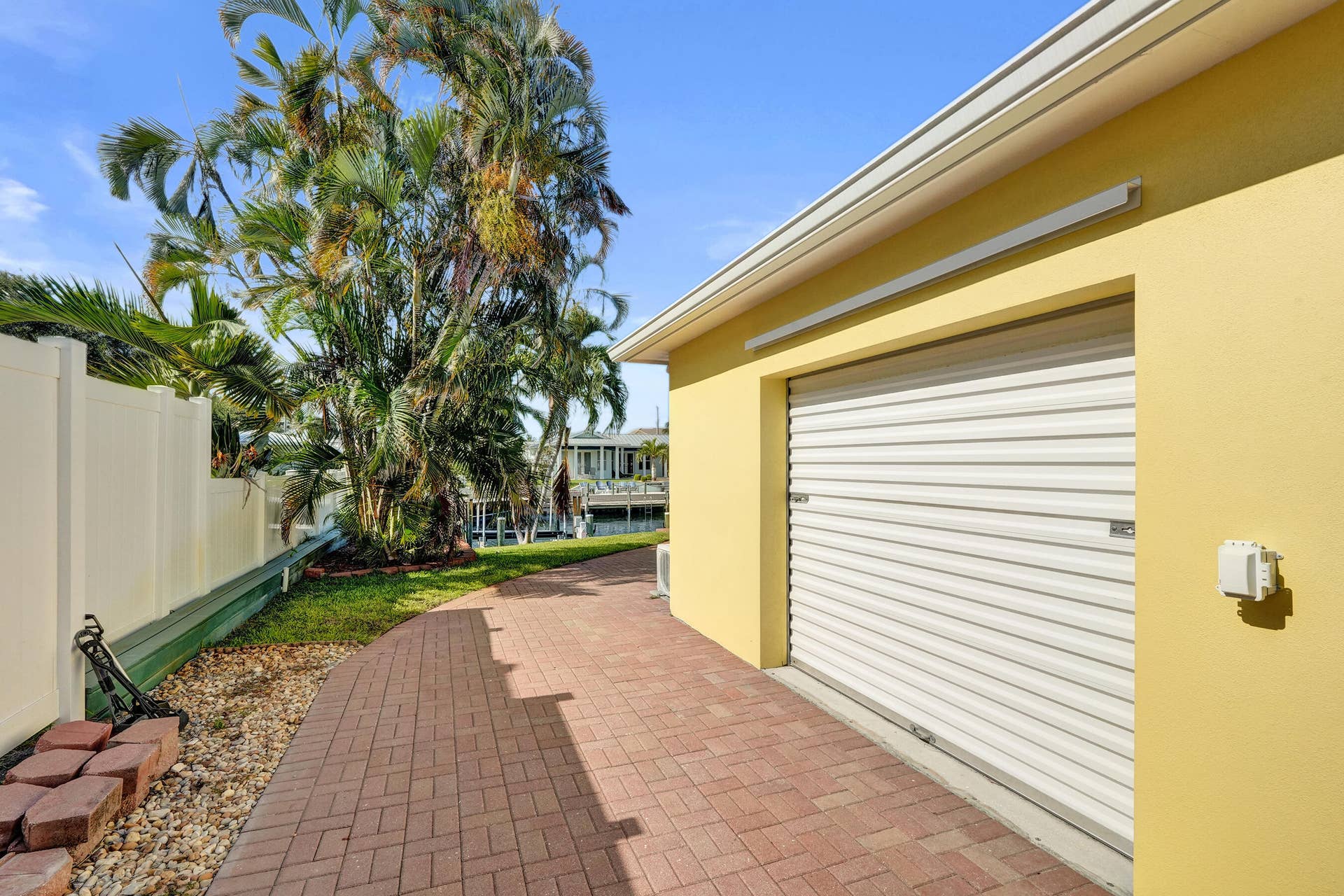 733 JACANA Way, North Palm Beach, FL 33408 Side yard with 30 AMP RV hookup and workshop.