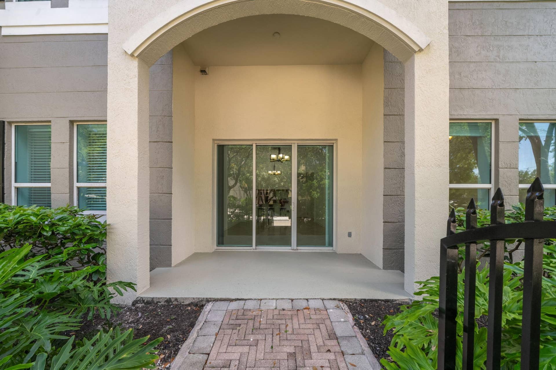 610 W Las Olas Boulevard, #115N, Fort Lauderdale, FL 33312 Private covered patio outside the living area, offering a sheltered outdoor extension of the residence surrounded by tropical landscaping.