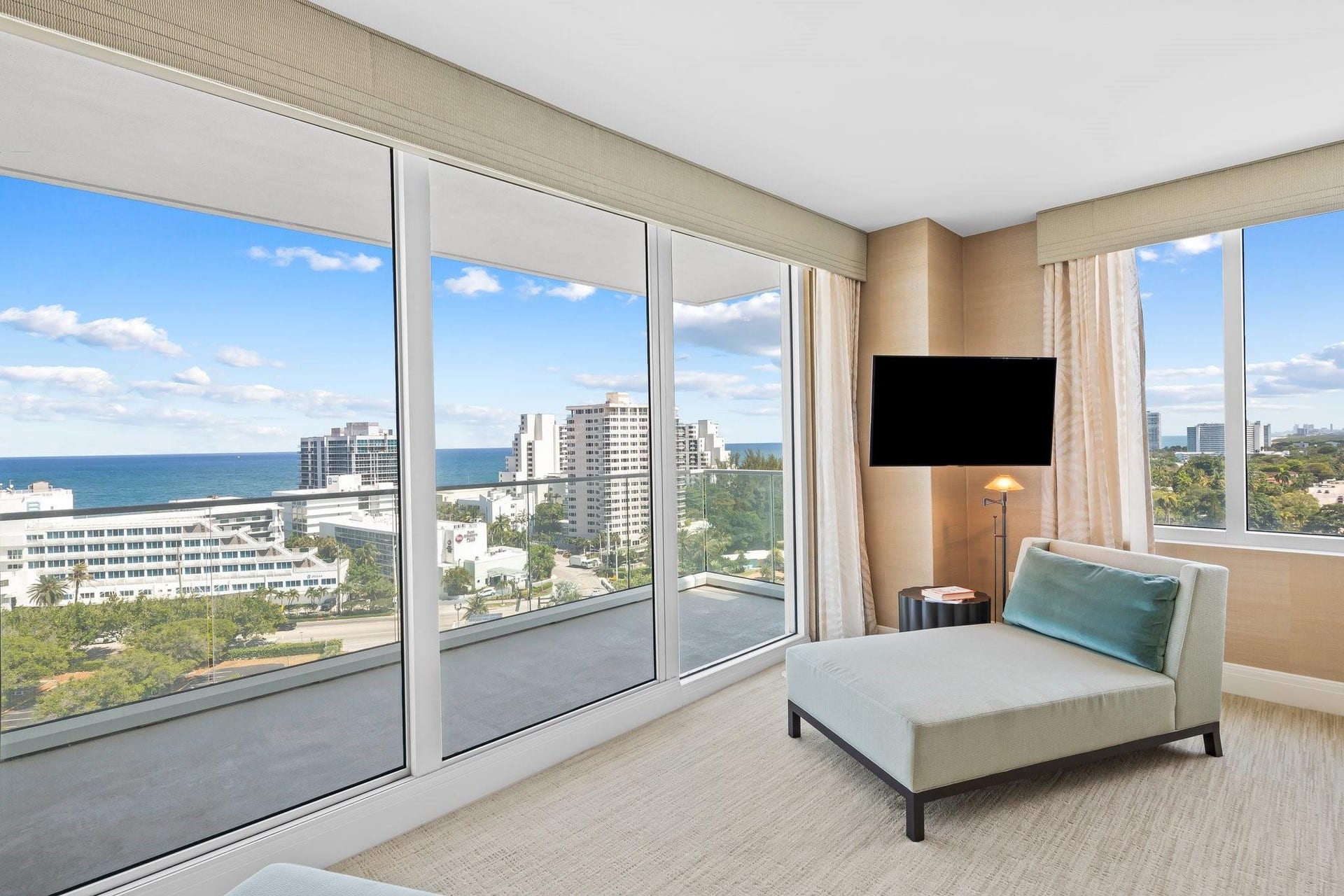 3055 Harbor Drive, #1403, Fort Lauderdale, FL 33316 Floor-to-ceiling glass doors opening onto an expansive balcony, featuring an ocean and city backdrop