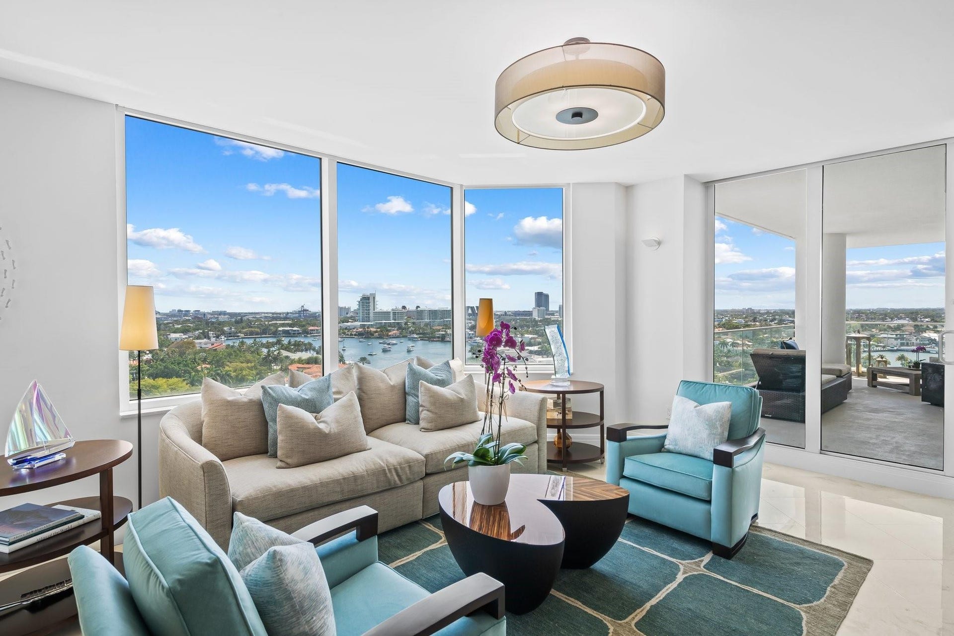 3055 Harbor Drive, #1403, Fort Lauderdale, FL 33316 Living area featuring floor-to-ceiling windows, polished tile flooring, a contemporary drum pendant light, and direct access to an outdoor balcony