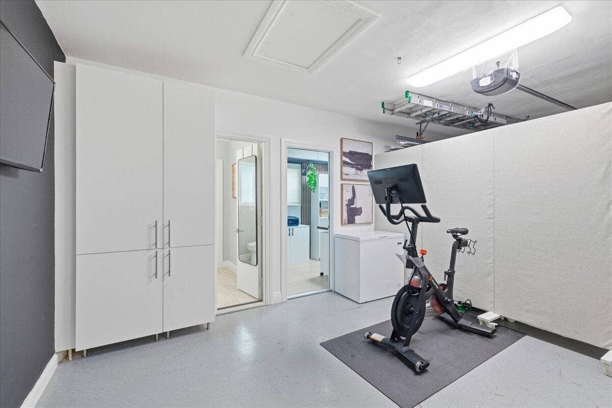 2210 NE 34TH Court, Lighthouse Point, FL 33064 garage with pantry and peloton