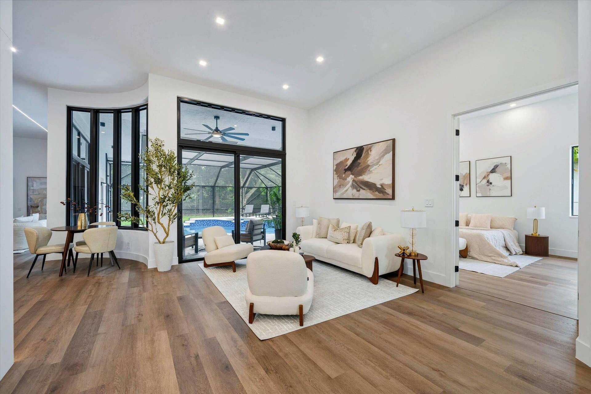 Formal Living Room overlooks pool/patio. Light comes in everywhere!