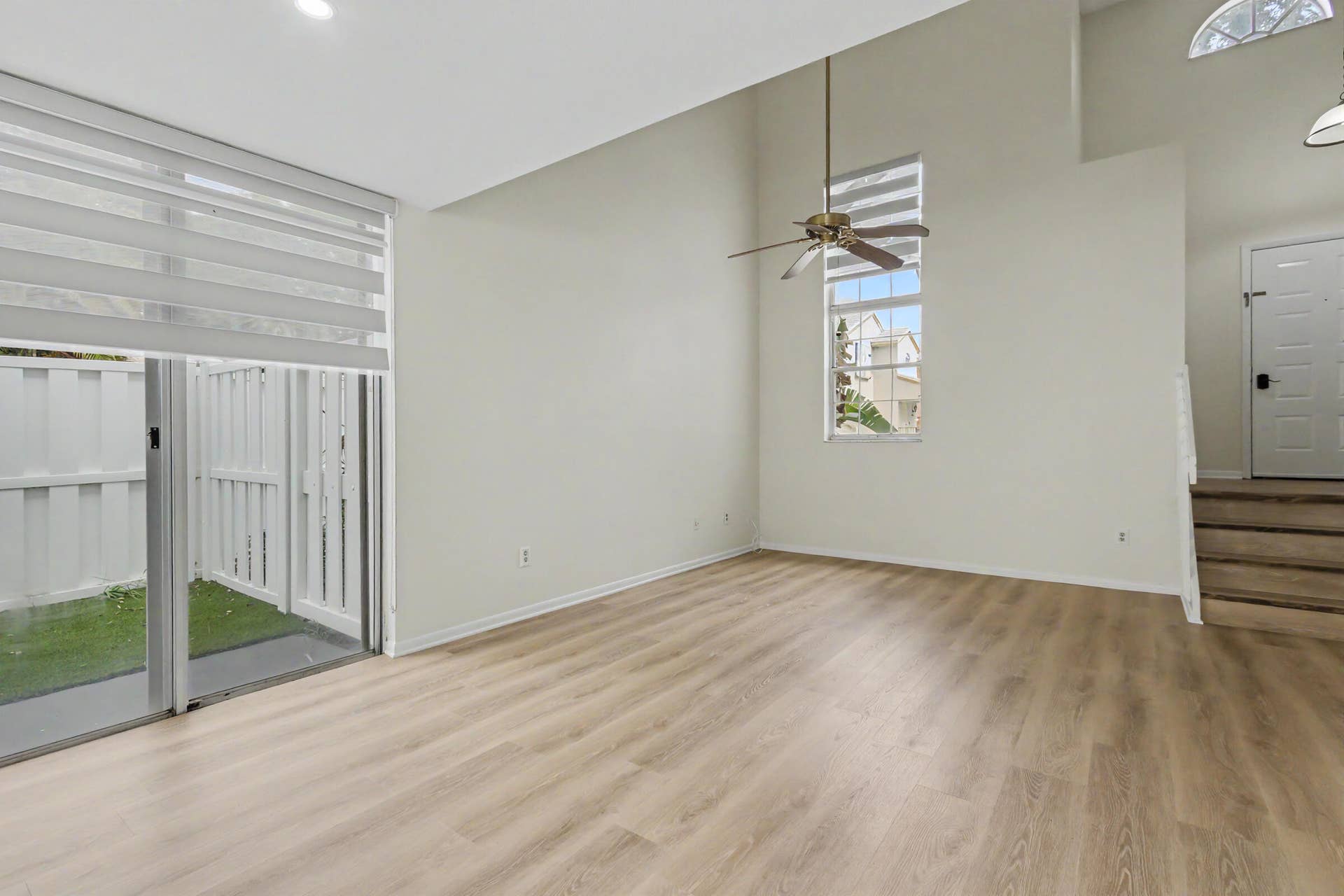 Sliding glass doors to side yard with upgraded window coverings