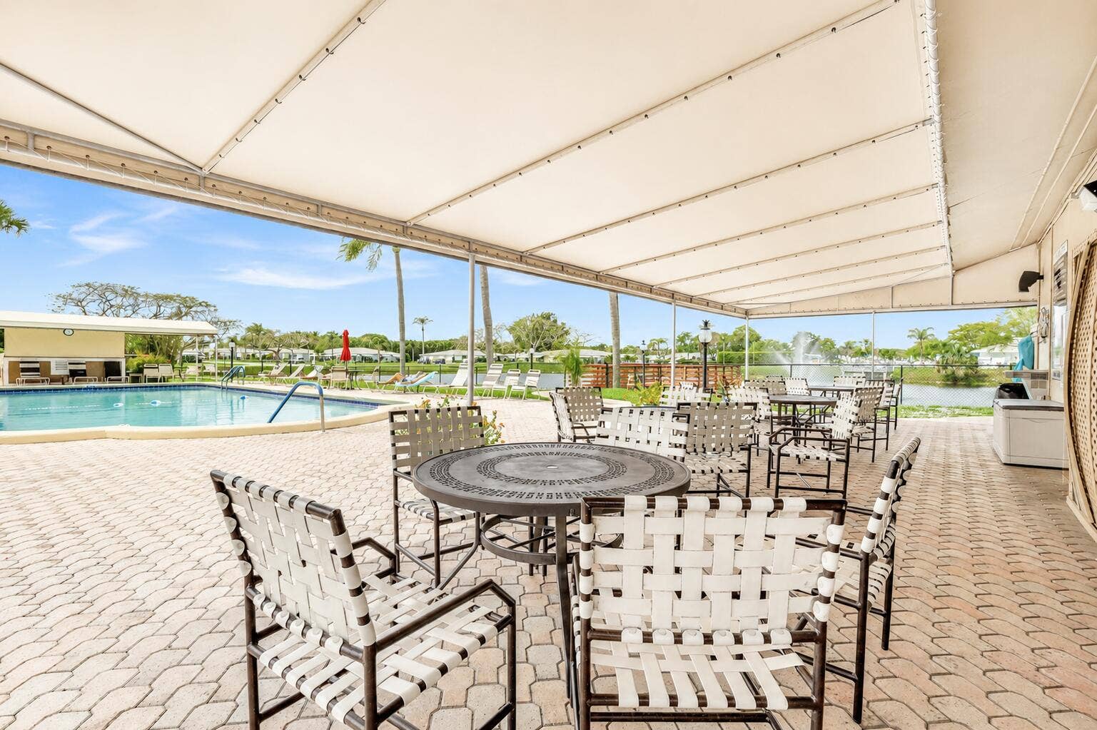 512 High Point Drive, #C, Delray Beach, FL 33445 pool area with chairs