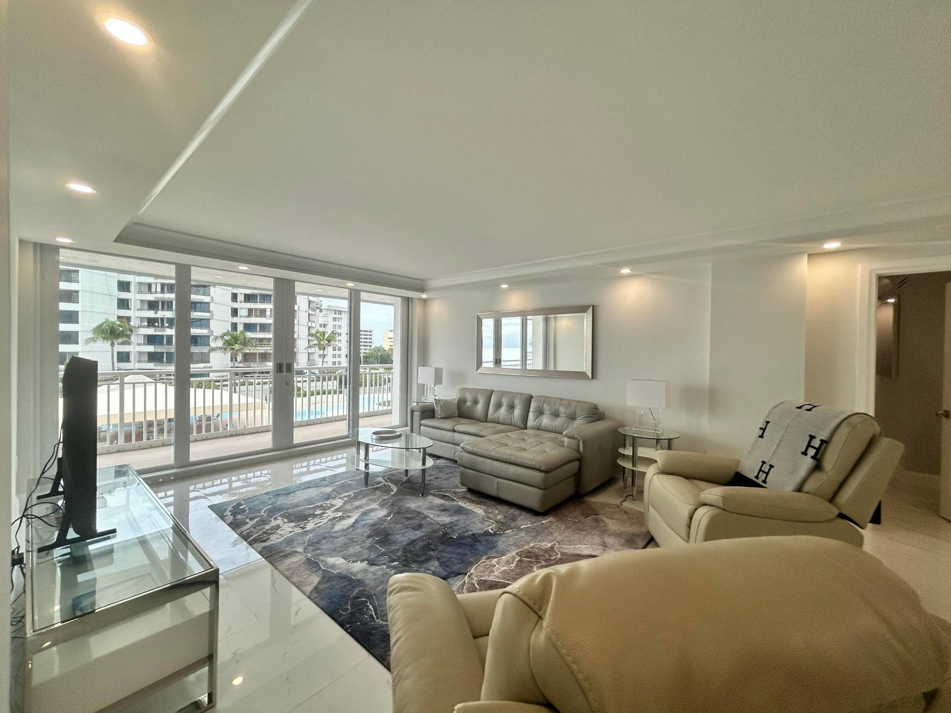 Living area featuring expansive glass sliding doors opening to an outdoor space