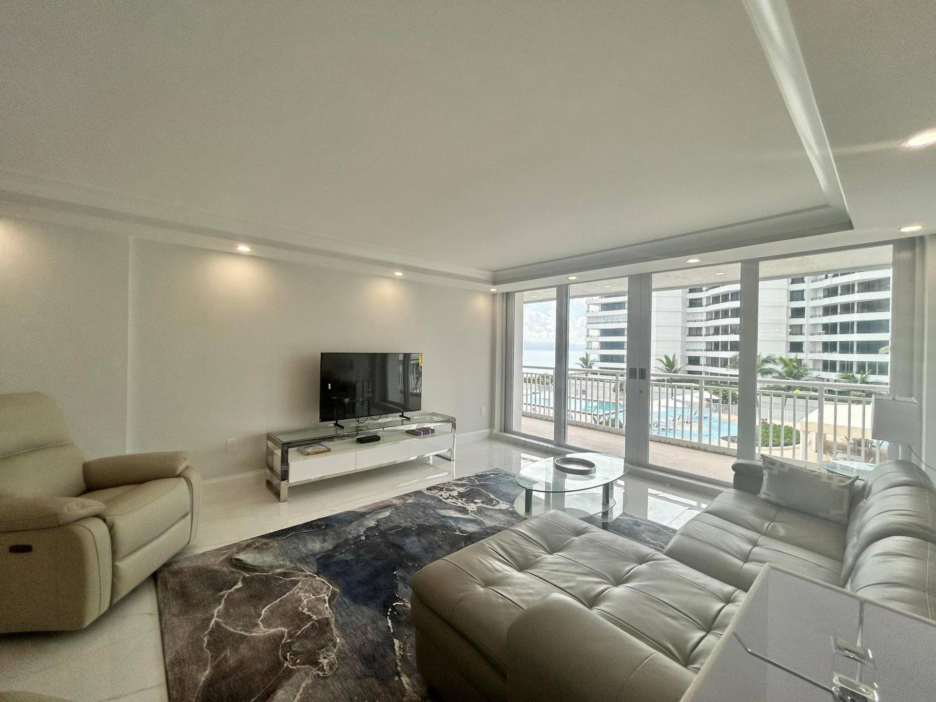 Living area with tile flooring and recessed lighting