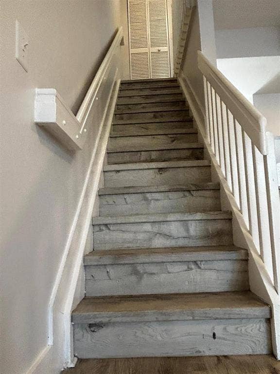 Staircase with wood-finish treads and white painted handrails