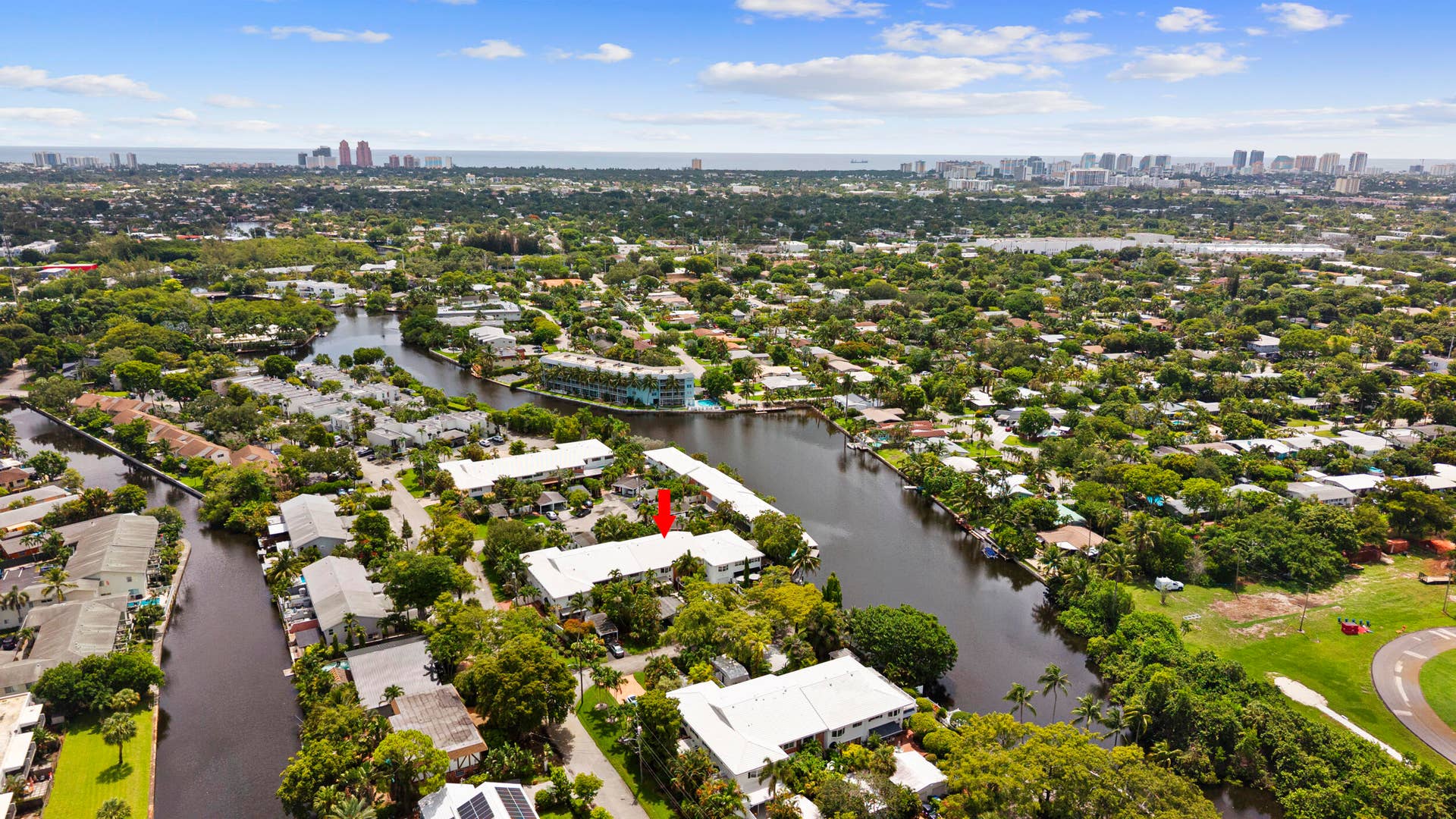 7 Middlesex Drive, Wilton Manors, FL 33305 Aerial view showcasing a riverfront property nestled within a lush, tree-lined neighborhood