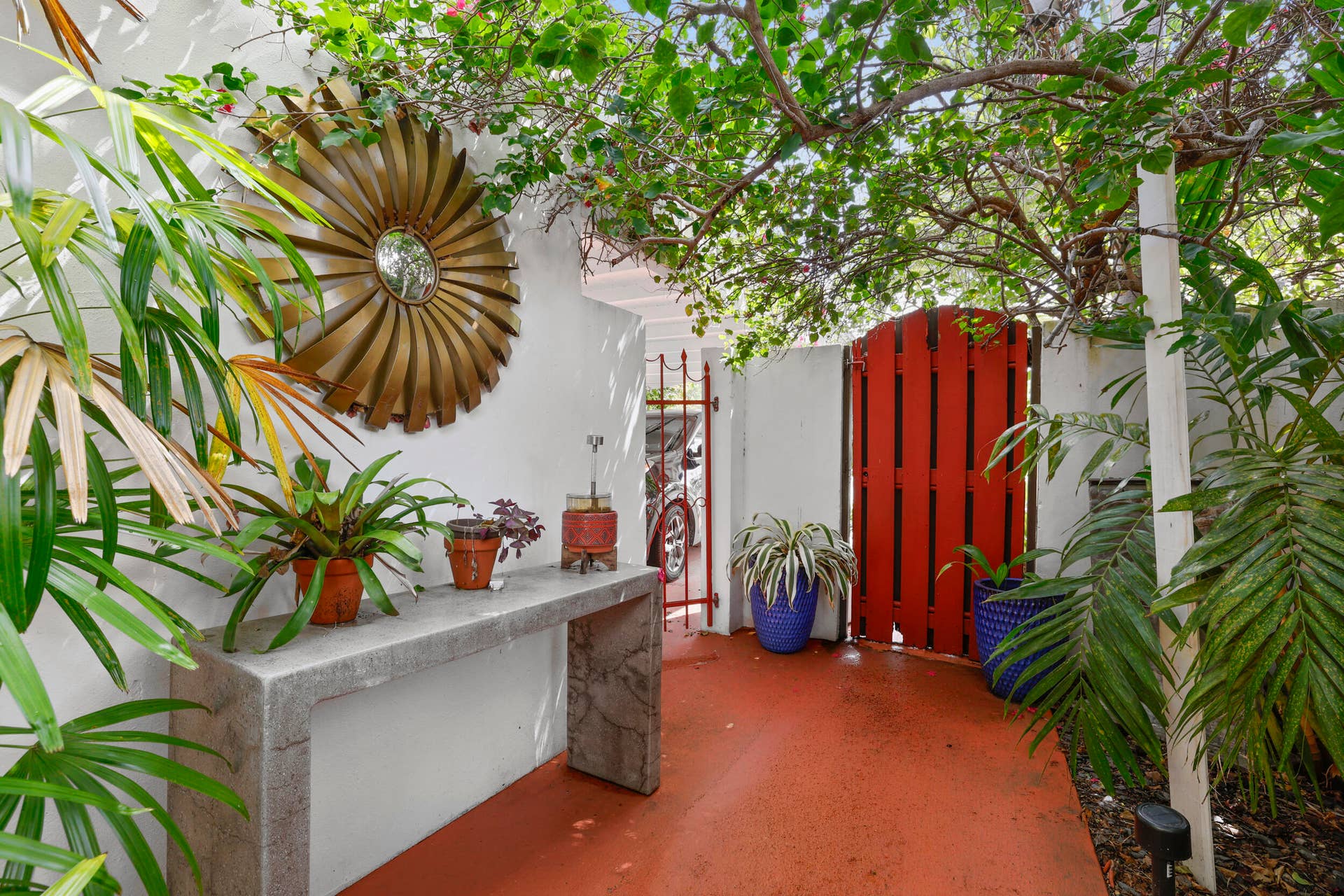 7 Middlesex Drive, Wilton Manors, FL 33305 Charming courtyard featuring terracotta tile flooring, whitewashed walls, and lush tropical plantry throughout