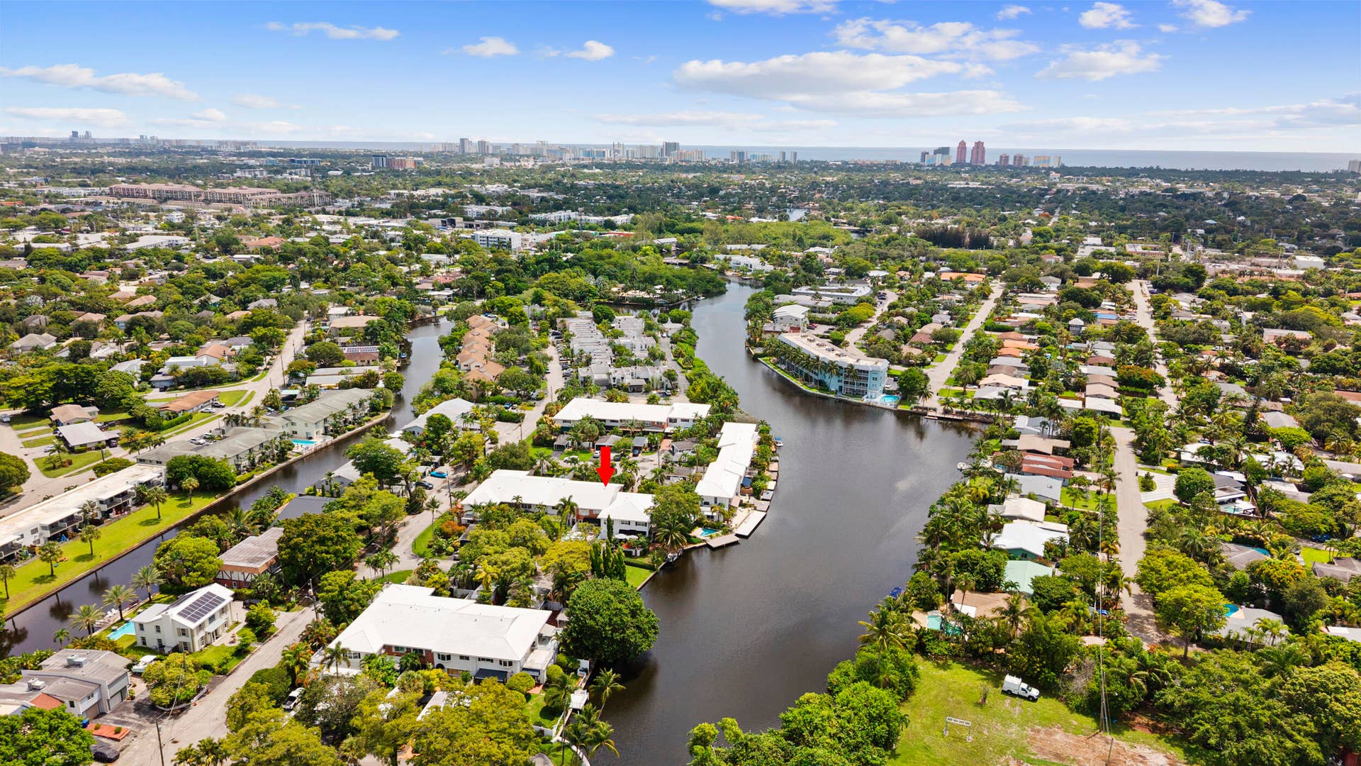 7 Middlesex Drive, Wilton Manors, FL 33305 Aerial view showcasing this waterfront property nestled within a lush, tree-lined neighborhood