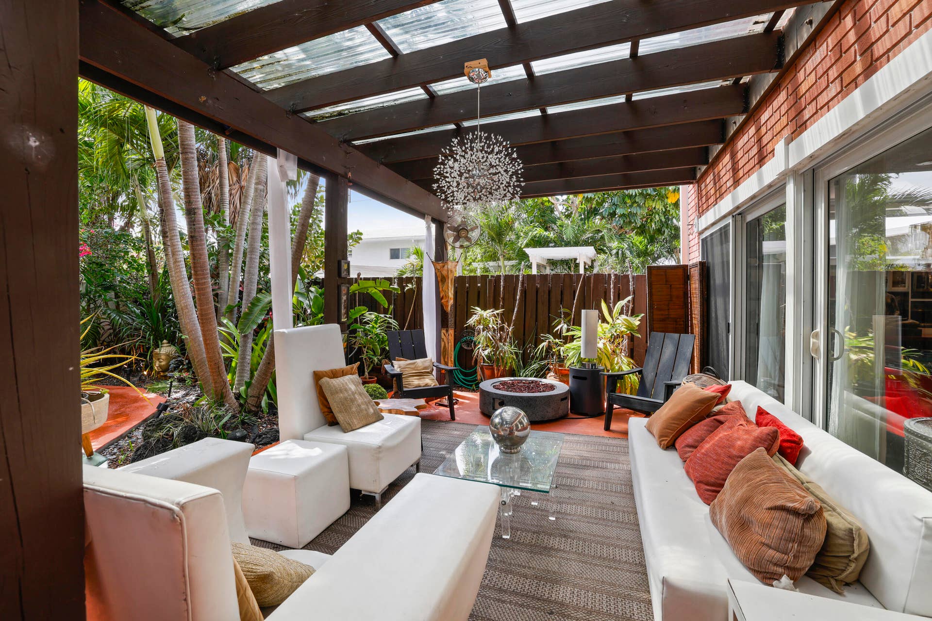 7 Middlesex Drive, Wilton Manors, FL 33305 Covered patio featuring a clear panel roof and dark wood beams