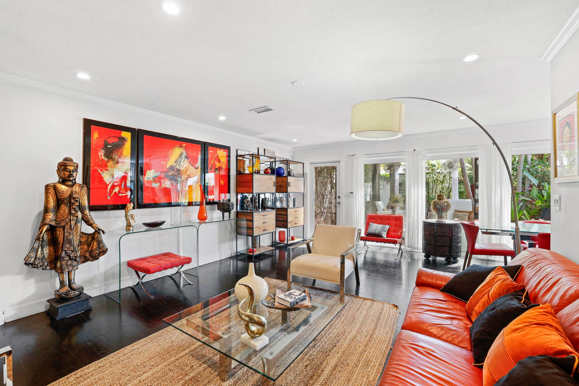 7 Middlesex Drive, Wilton Manors, FL 33305 Contemporary living space featuring floor-to-ceiling glass doors and windows flooding the room with natural light, complemented by recessed ceiling lighting