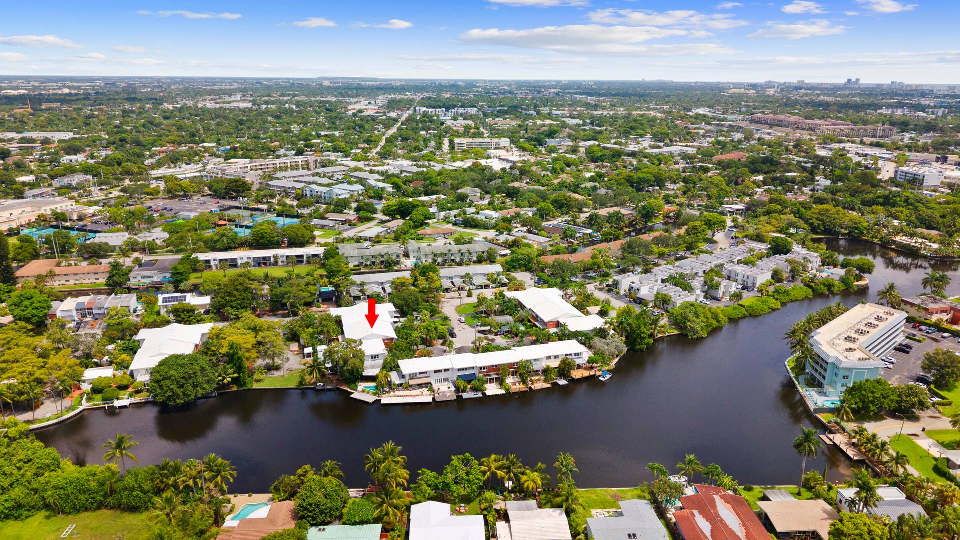 7 Middlesex Drive, Wilton Manors, FL 33305 Waterfront property featuring a pristine riverfront setting with mature landscaping, expansive grounds, and direct water access
