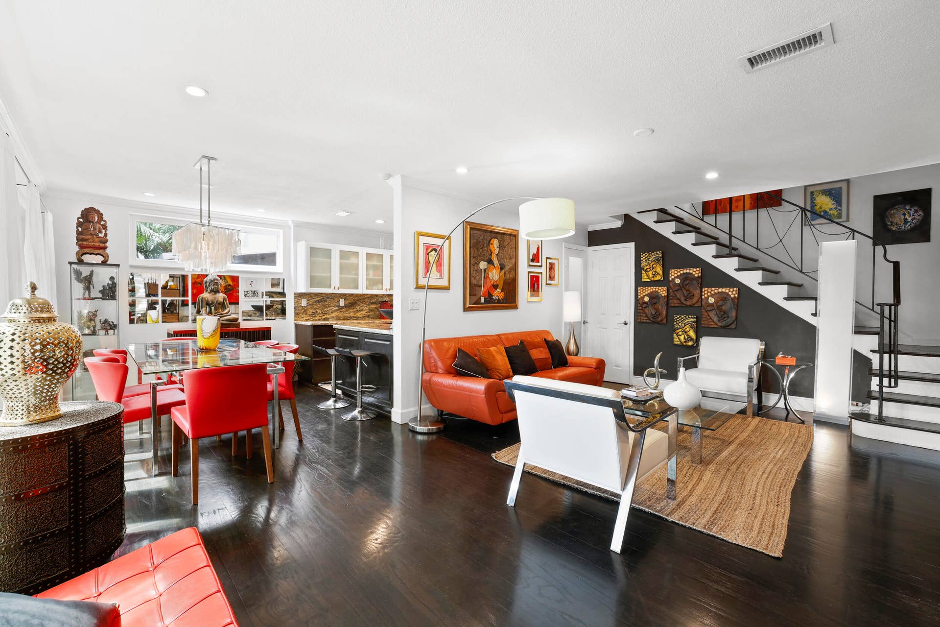 7 Middlesex Drive, Wilton Manors, FL 33305 Open-concept living space featuring dark wood-finish flooring, soaring ceilings with recessed lighting, and a striking staircase with metal railings