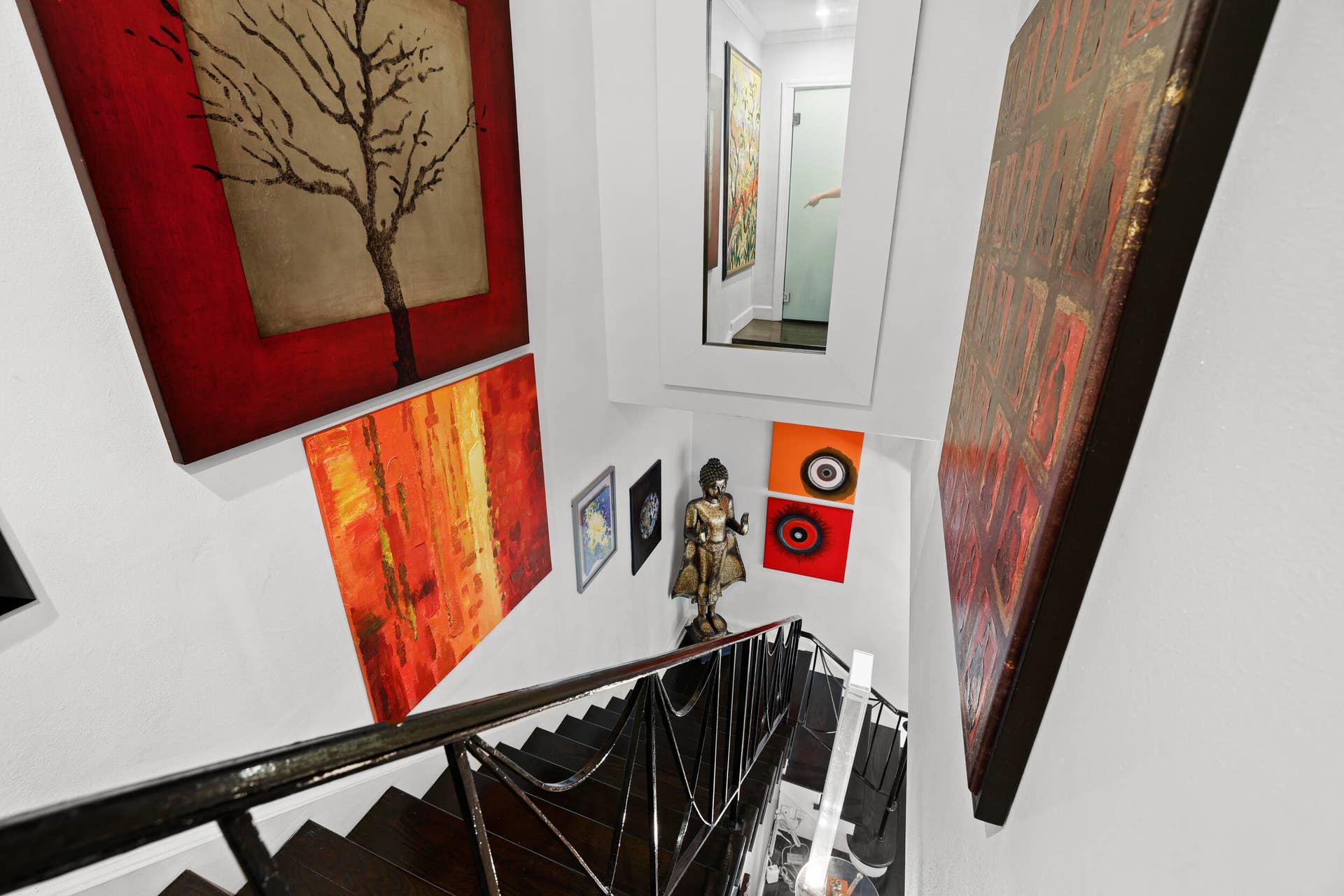 7 Middlesex Drive, Wilton Manors, FL 33305 Stairwell featuring dark-toned treads, a black iron railing, and white walls