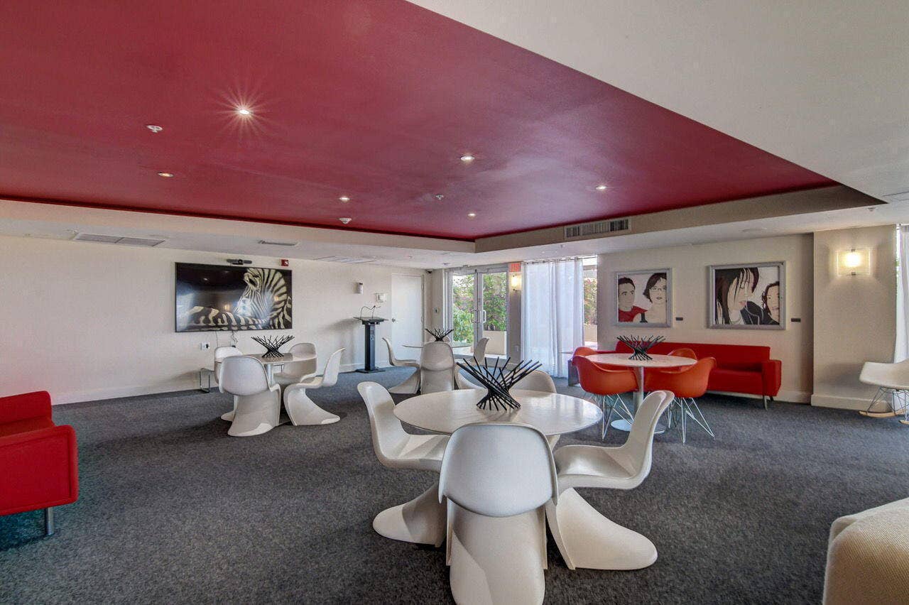 Spacious common area featuring recessed lighting, a media wall, and carpet flooring