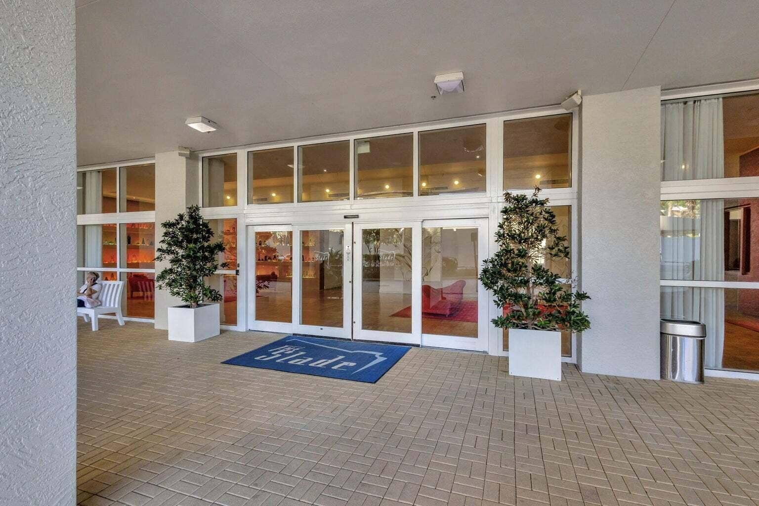 Entryway featuring expansive glass doors, surrounding windows, and recessed lighting