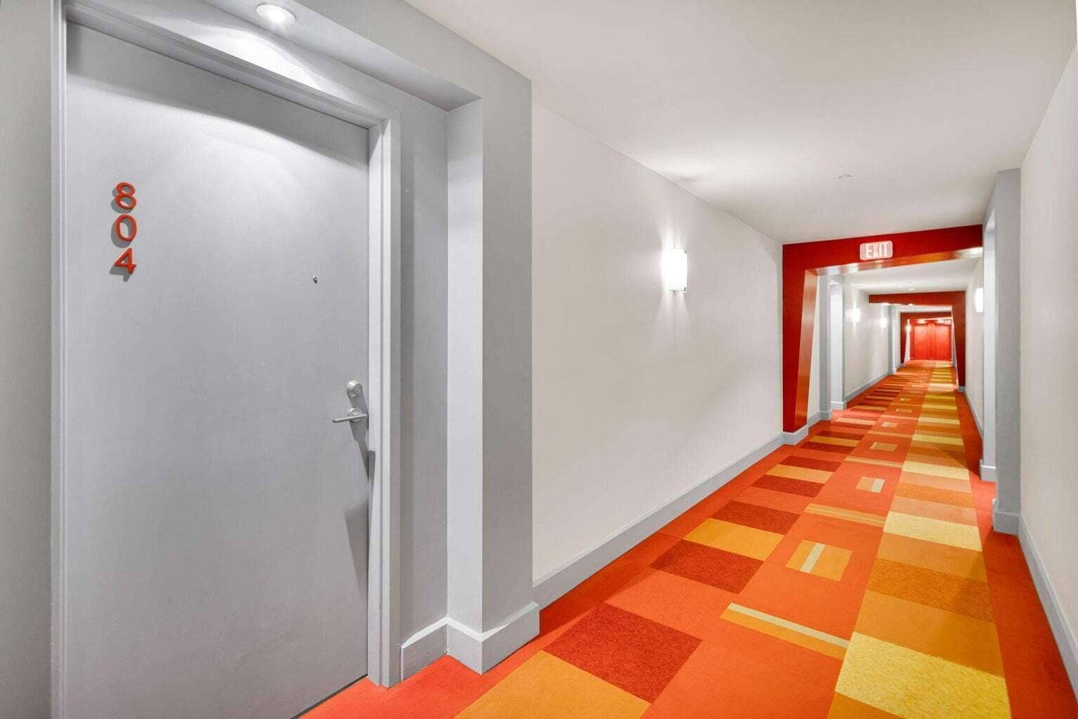 Entry door featuring modern hardware and recessed lighting