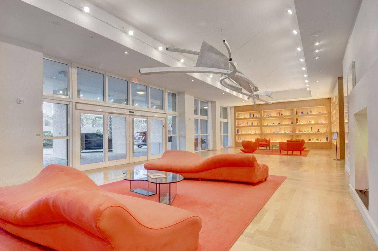 Spacious lobby area featuring light wood-finish flooring, recessed lighting, and a modern ceiling fixture