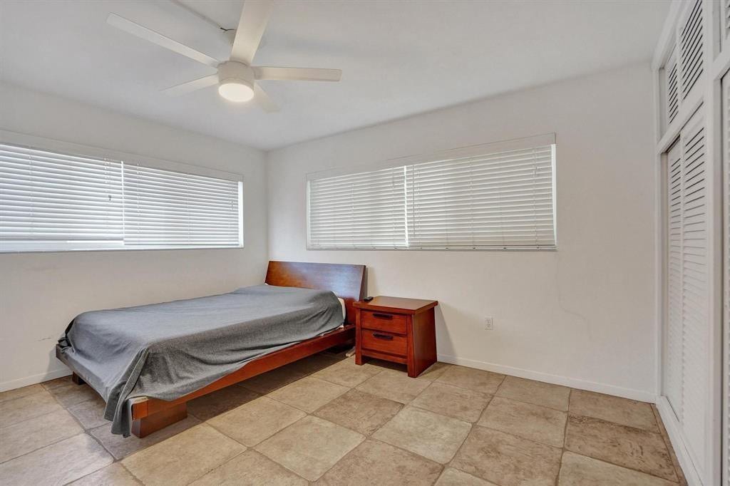 2760 YACHT CLUB Boulevard, #10C, Fort Lauderdale, Fort Lauderdale, FL 33304 Spacious bedroom featuring tile flooring, high ceilings with ceiling fan, and dual transom windows providing natural light
