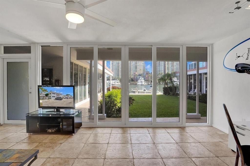 2760 YACHT CLUB Boulevard, #10C, Fort Lauderdale, Fort Lauderdale, FL 33304 Tile flooring throughout a bright room featuring a white ceiling fan with integrated lighting