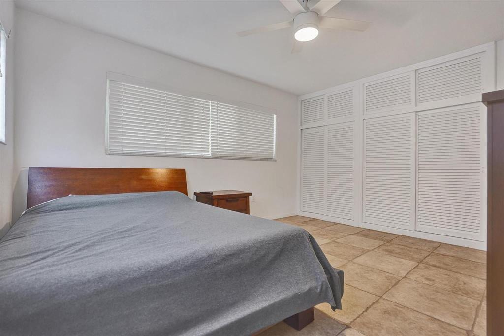 2760 YACHT CLUB Boulevard, #10C, Fort Lauderdale, Fort Lauderdale, FL 33304 Spacious bedroom featuring a wood-finish bed frame, tile flooring, and abundant natural light from transom windows