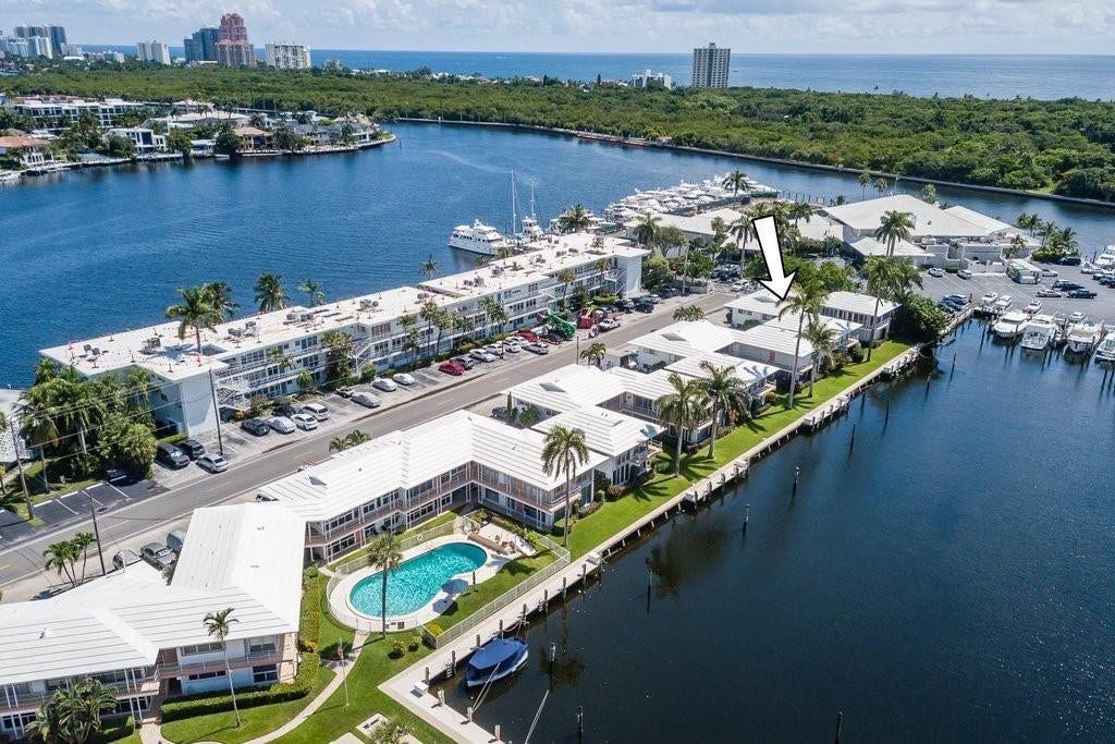 2760 YACHT CLUB Boulevard, #10C, Fort Lauderdale, Fort Lauderdale, FL 33304 Waterfront resort-style community featuring a modern multi-story residential building with direct marina access, resort-caliber swimming pool with lounge areas, manicured landscaping with mature palm trees, and expansive dockage for watercraft