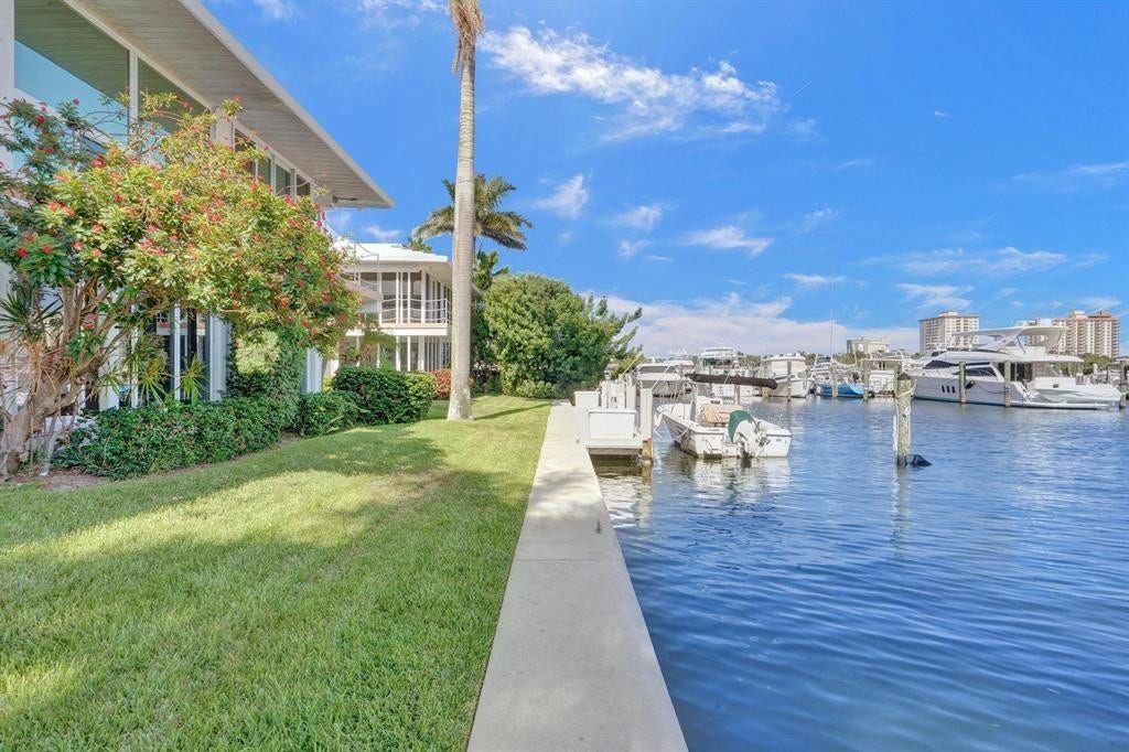 2760 YACHT CLUB Boulevard, #10C, Fort Lauderdale, Fort Lauderdale, FL 33304 Waterfront property featuring a private dock, direct water access, a manicured lawn, and lush landscaping