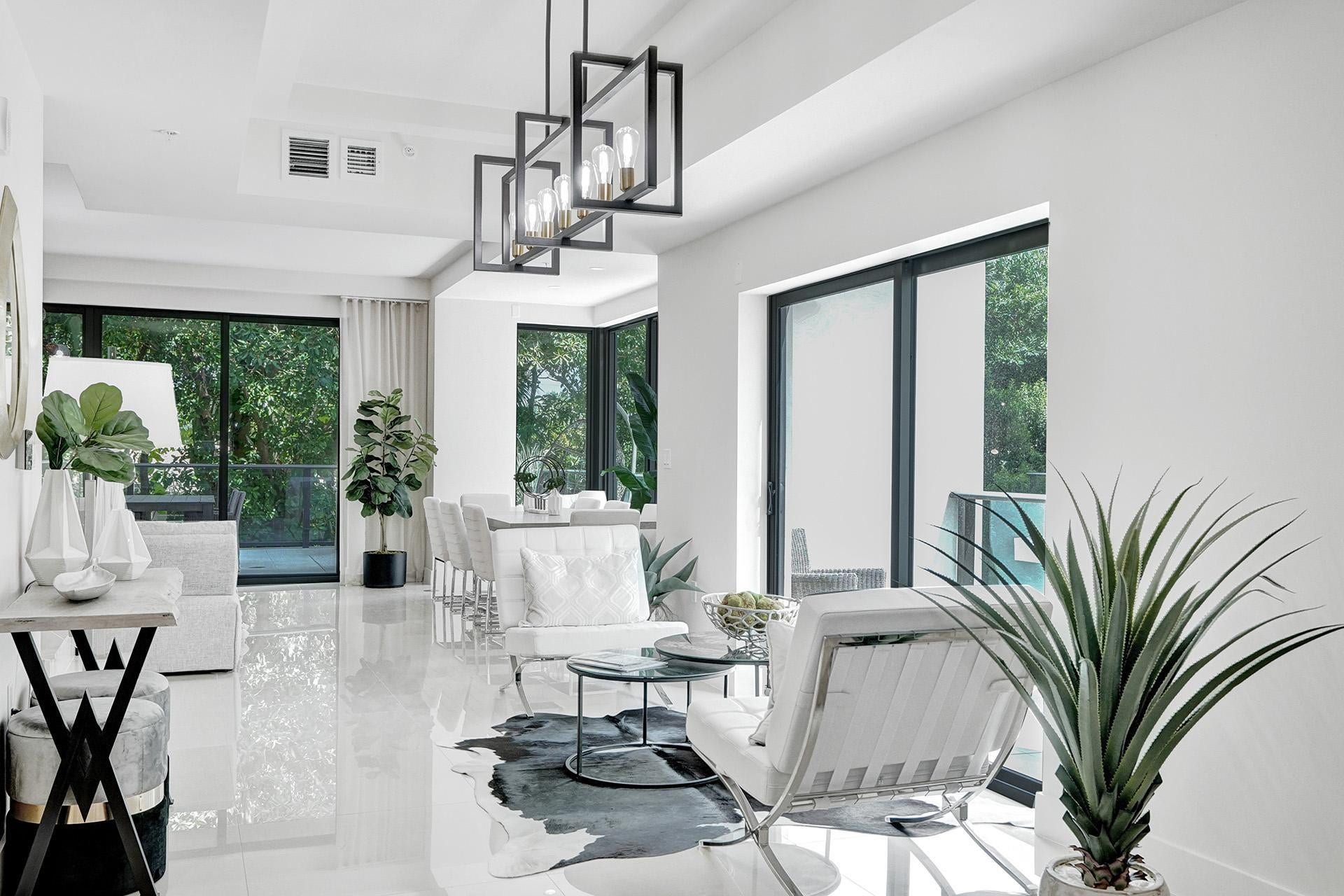 Open-concept living area featuring high-gloss tile flooring and floor-to-ceiling sliding glass doors