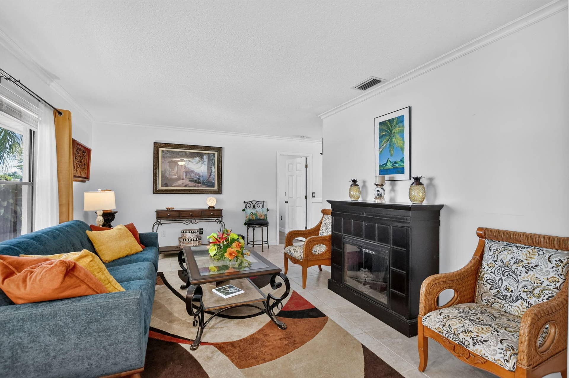Oversized living room has crown molding and knockdown finished ceiling.