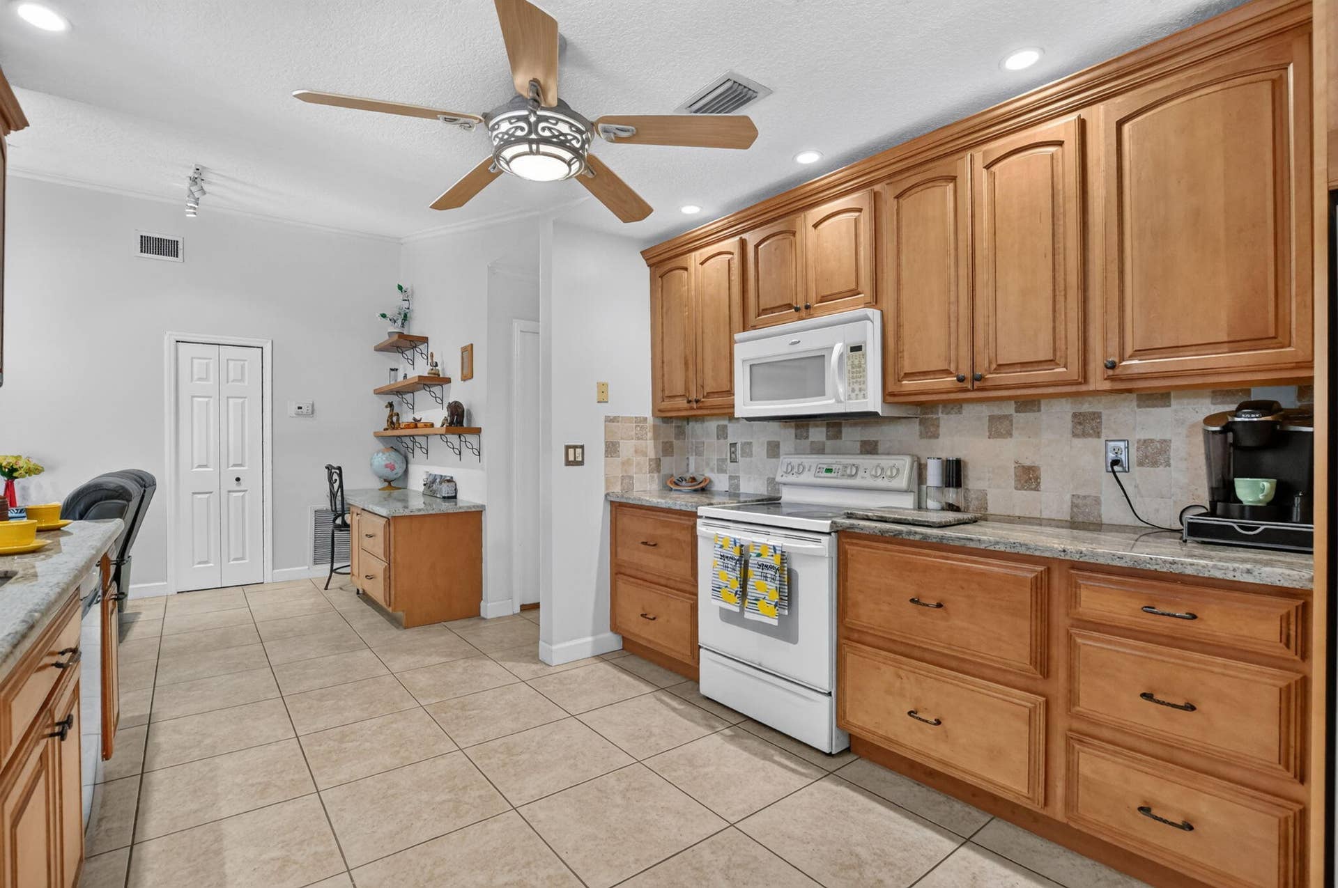 Prepare gourmet meals with your granite counters and full tumbled marble backsplash.