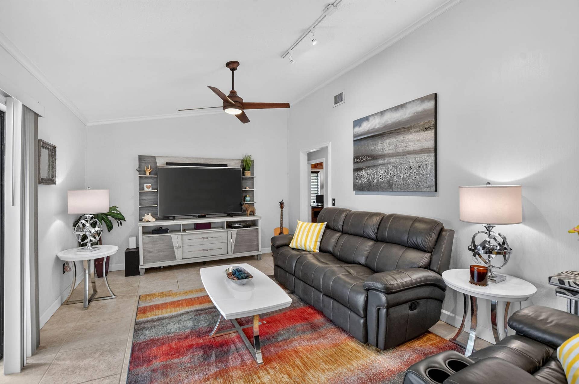 Large family room with soaring ceiling is ready for movie night.