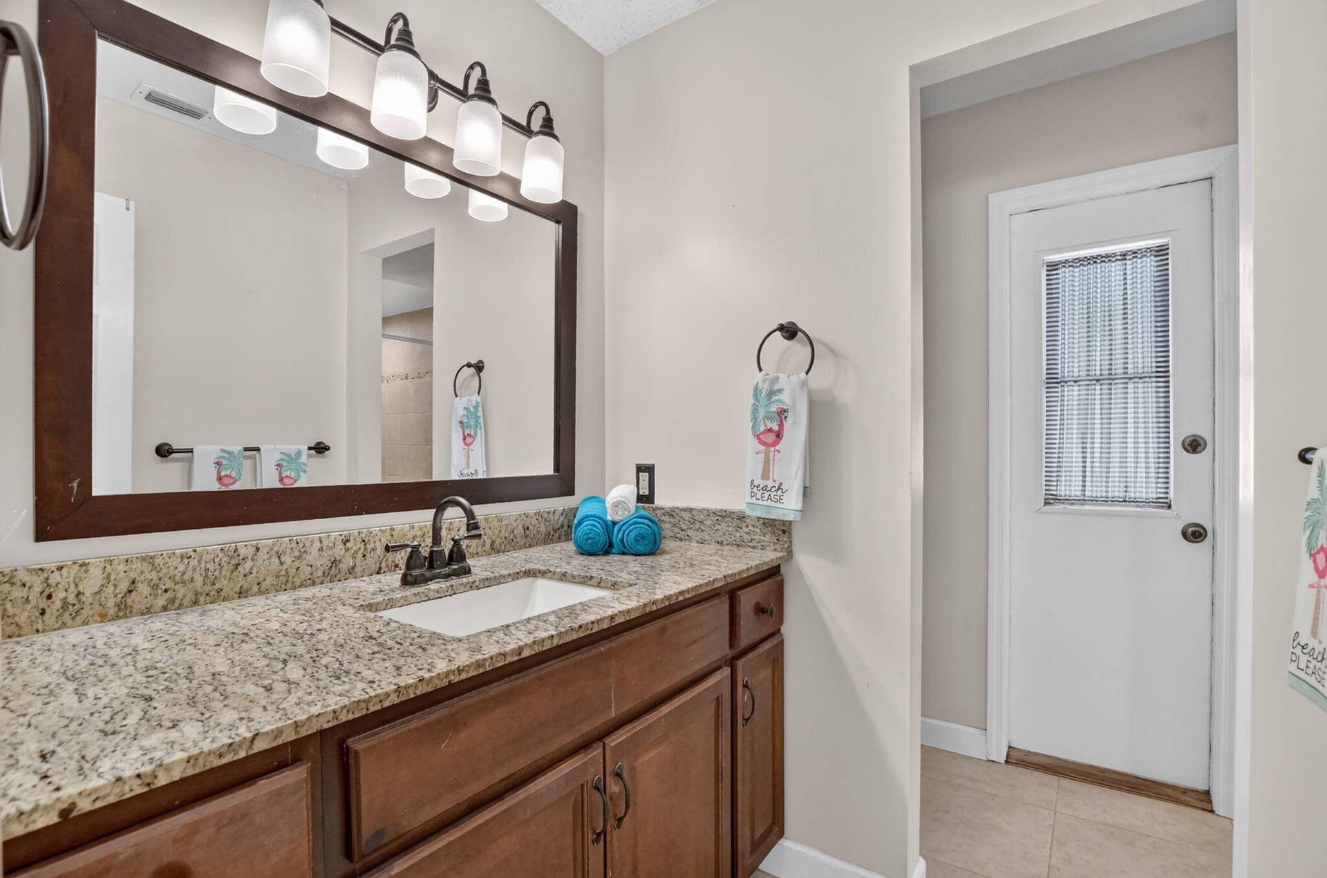 Primary bath features counter height vanity with granite counters and undermount sink.
