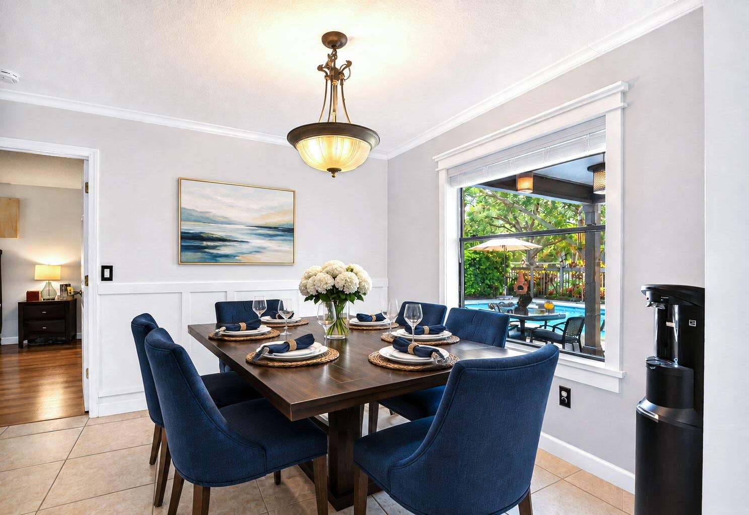 Dining area features a chair rail and overlooks the pool and patio.
